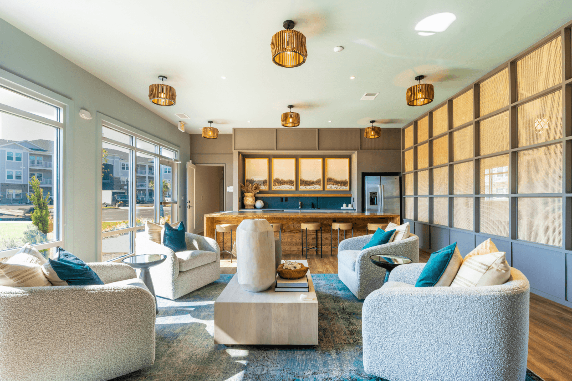 a living room with couches and chairs and a kitchen