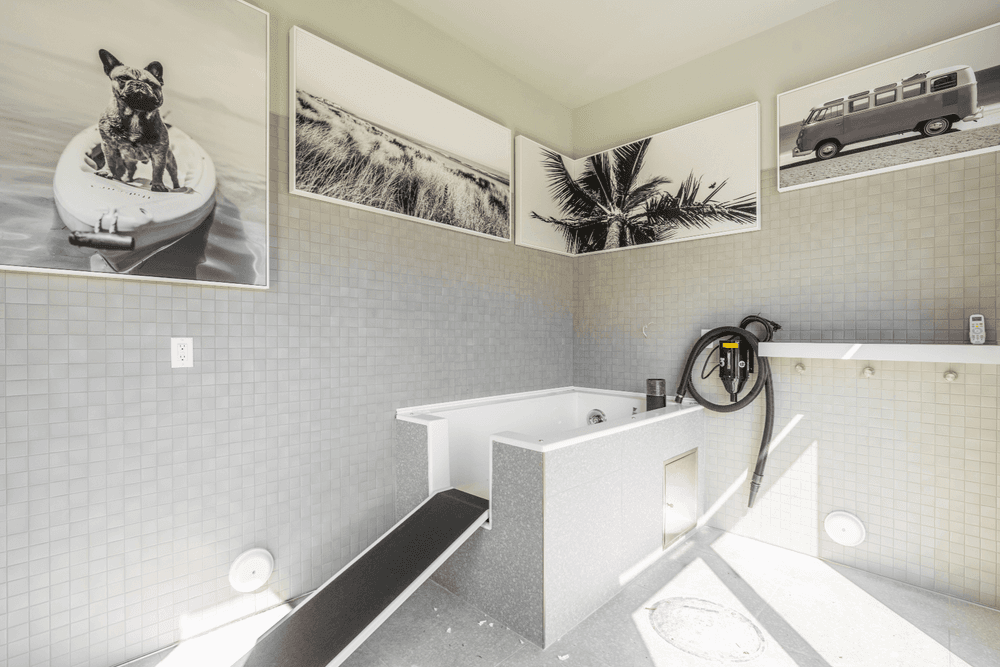 a bathroom with a tub and pictures on the wall