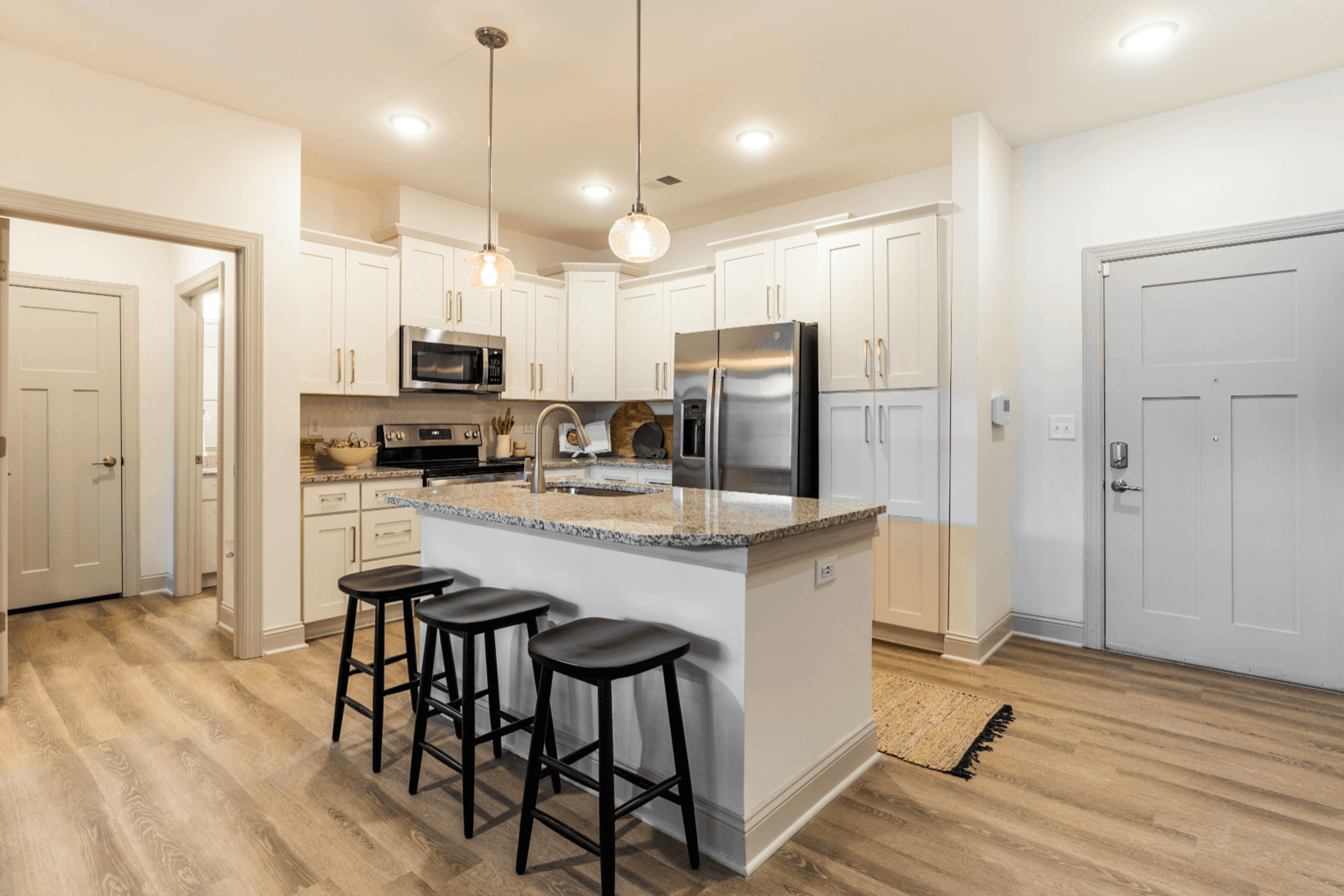 Modern Kitchen with Stand-Alone Island, Granite Countertops, Stainless Steel Appliances, and Designer Tile Backsplash