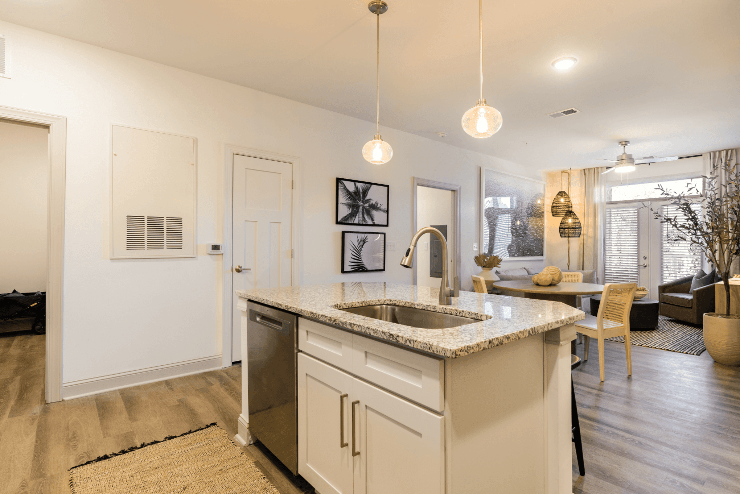 an open kitchen and living room with a sink and a table