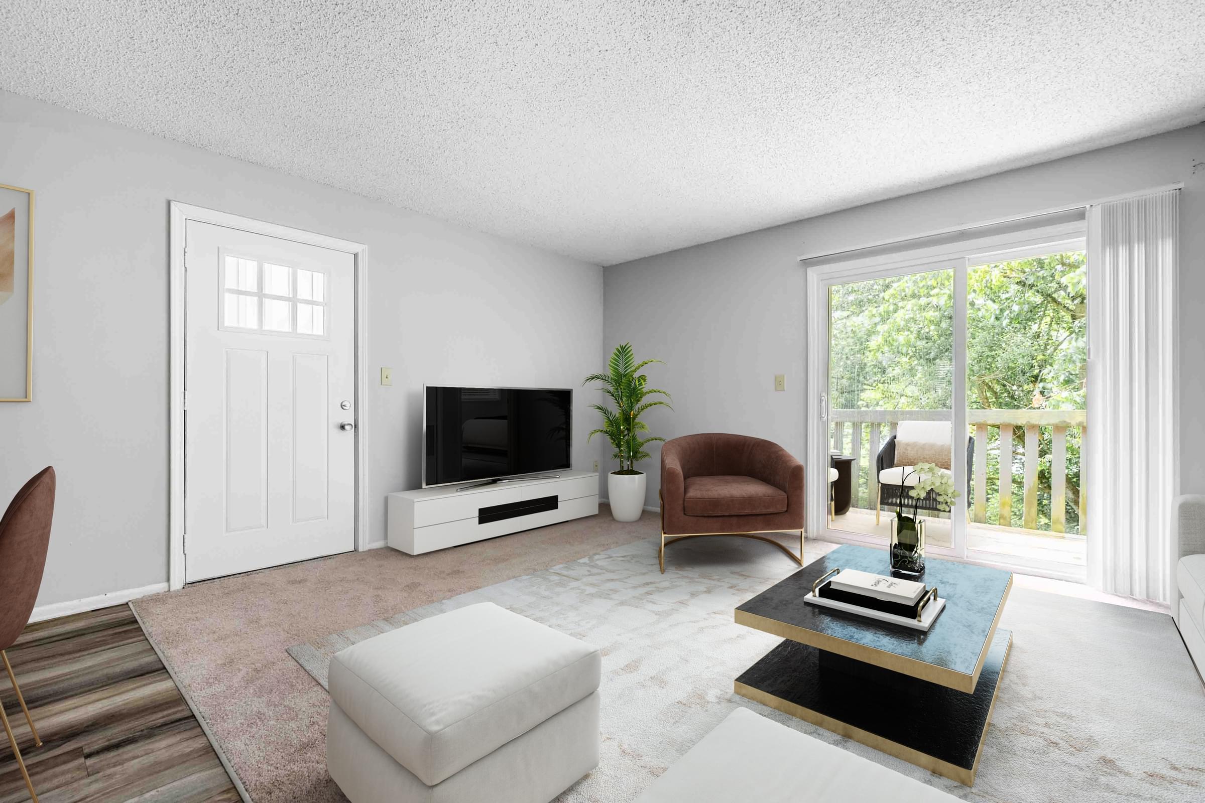 A living room with a brown chair, a white chair, a white ottoman, a black coffee table, a flat screen TV, and a plant.