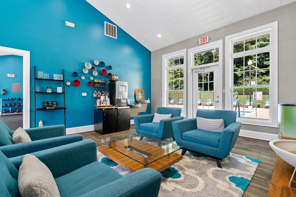 a living room with blue couches and chairs and a coffee table