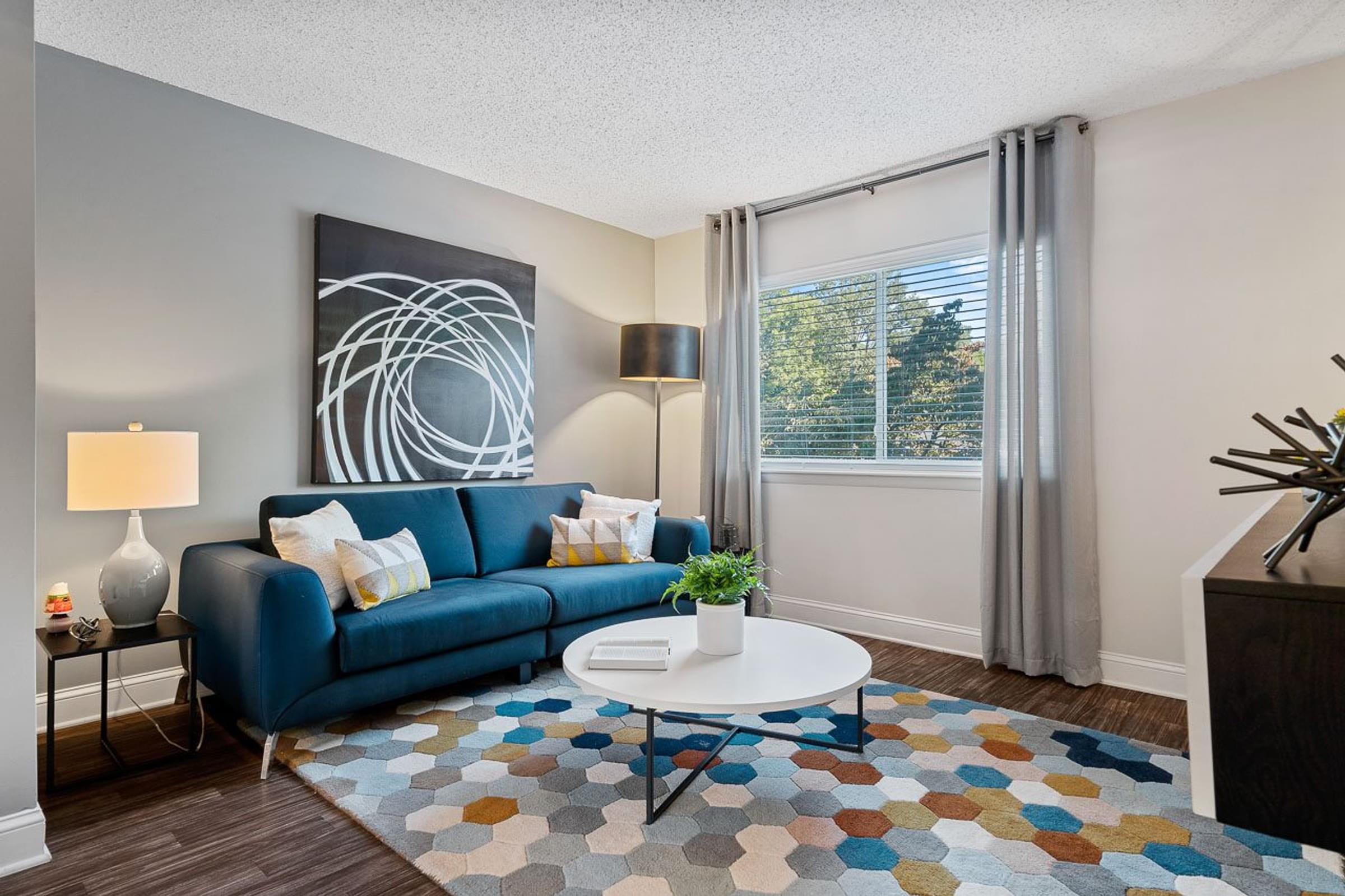 a living room with a blue couch and a coffee table