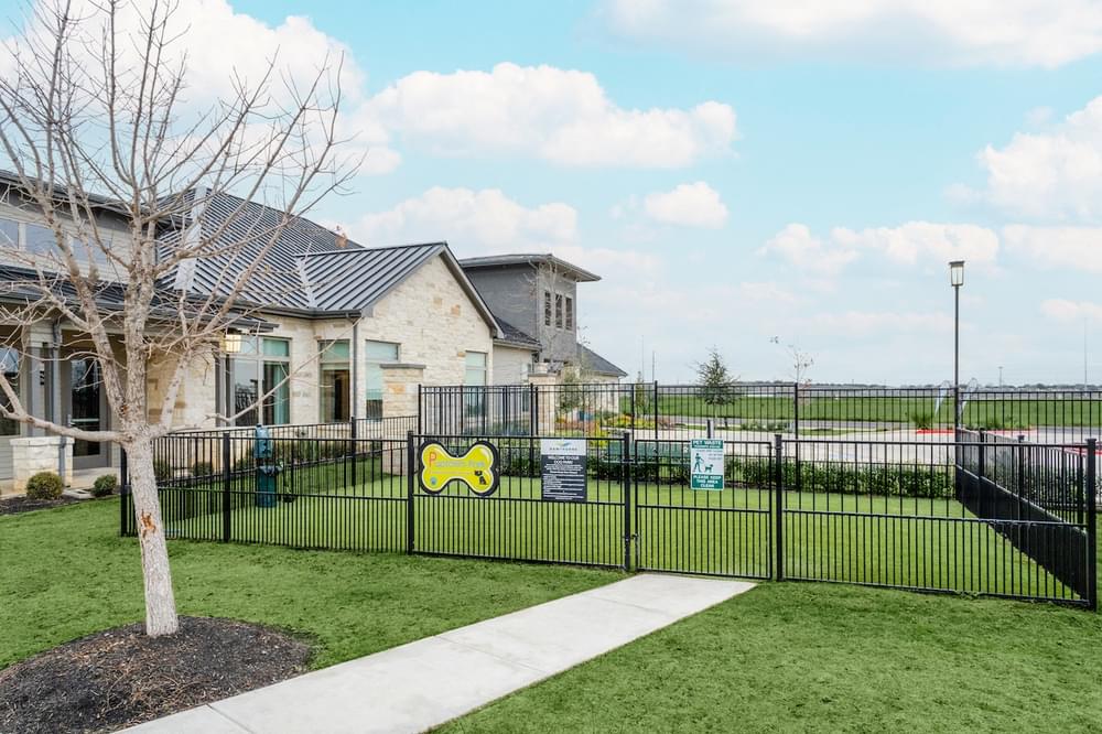 a yard with a fence in front of a house