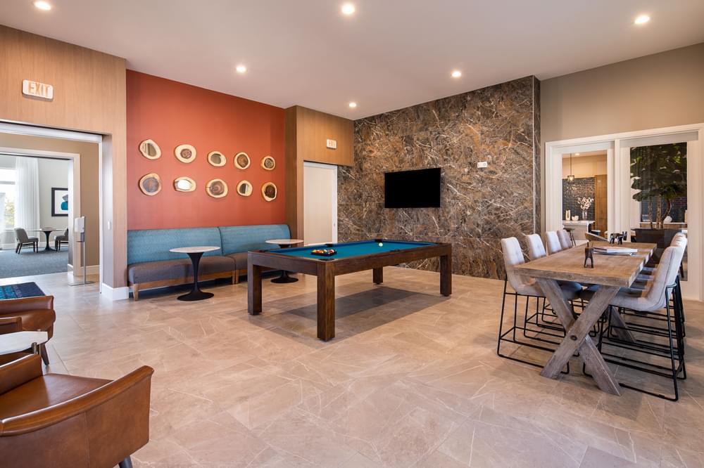 a game room with a pool table and tables