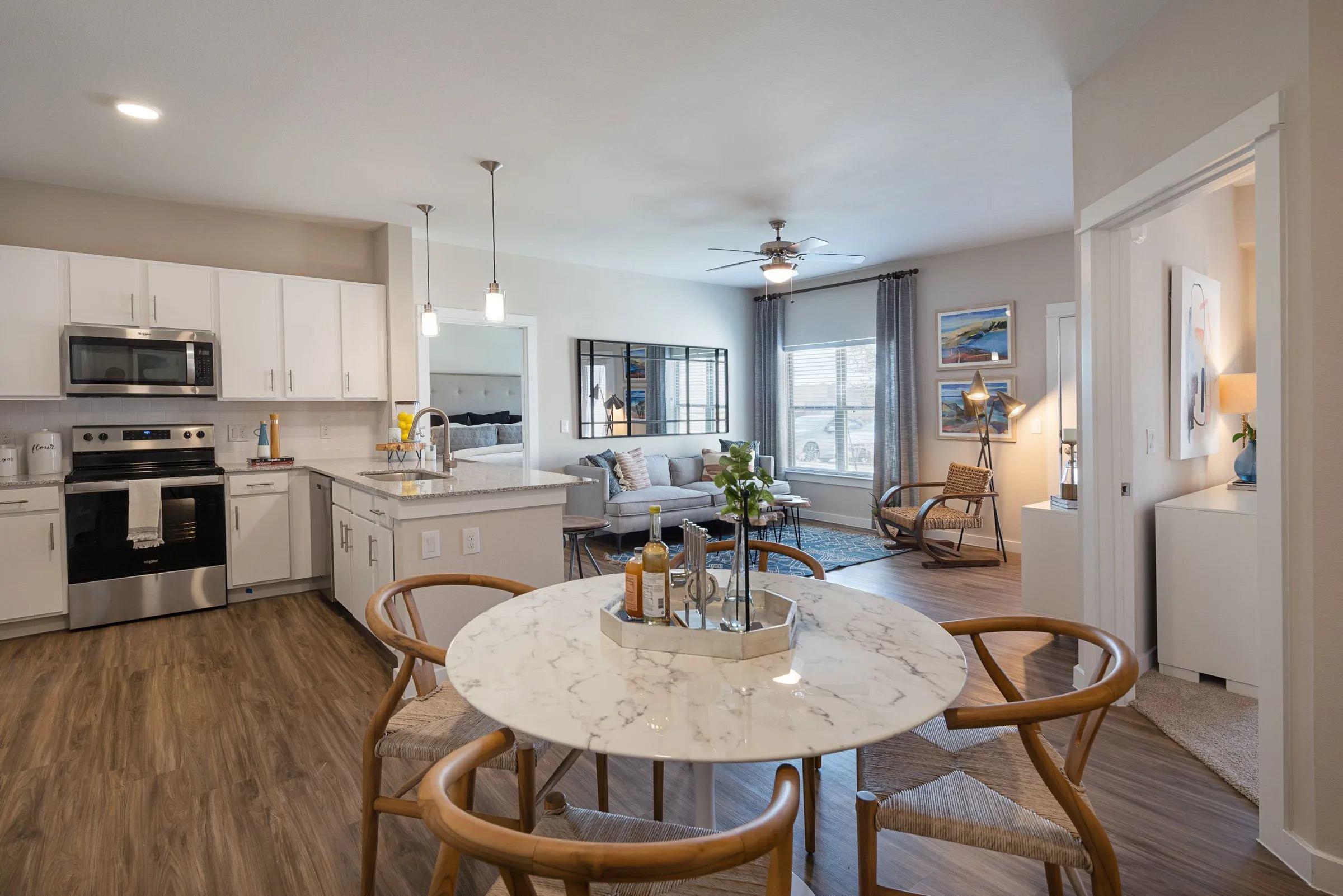 A modern kitchen with a dining table and chairs.