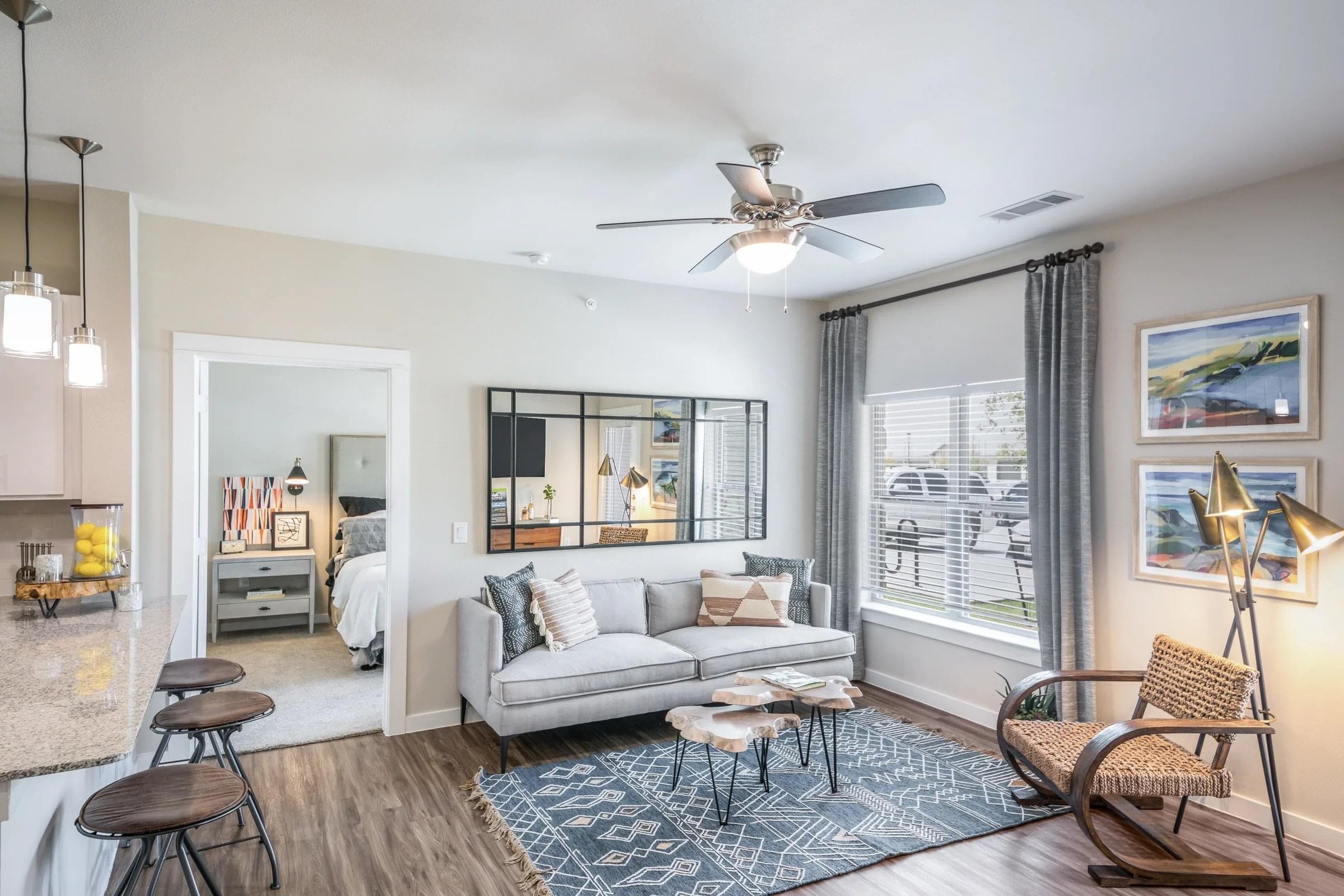 Spacious and Open-Concept Living Area With Ceiling Fan and Luxury Plank-Style Flooring
