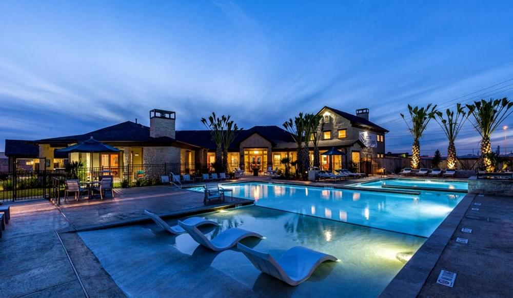 a house with a swimming pool at night