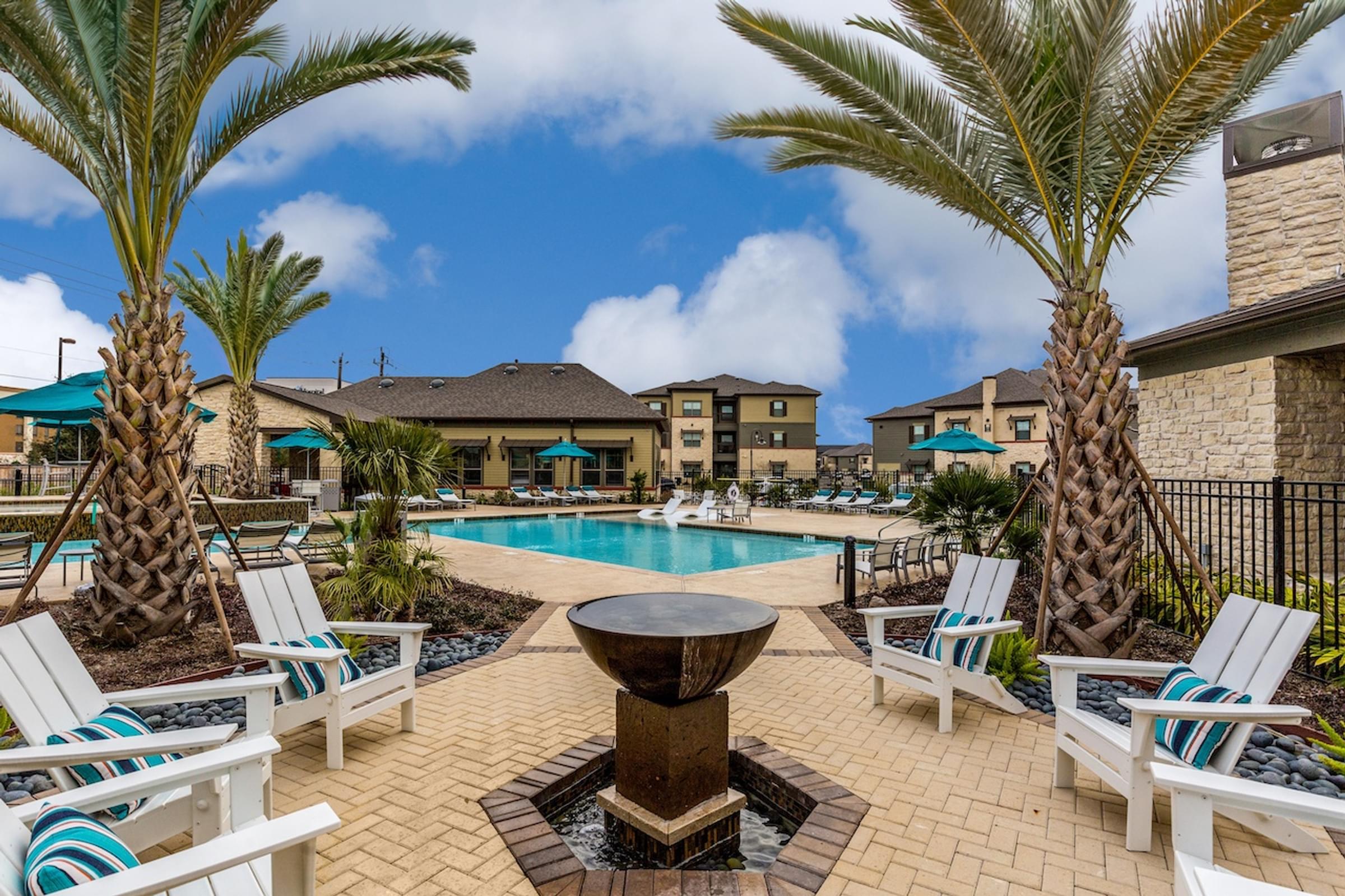 the preserve at ballantyne commons pool and spa with chairs and palm trees