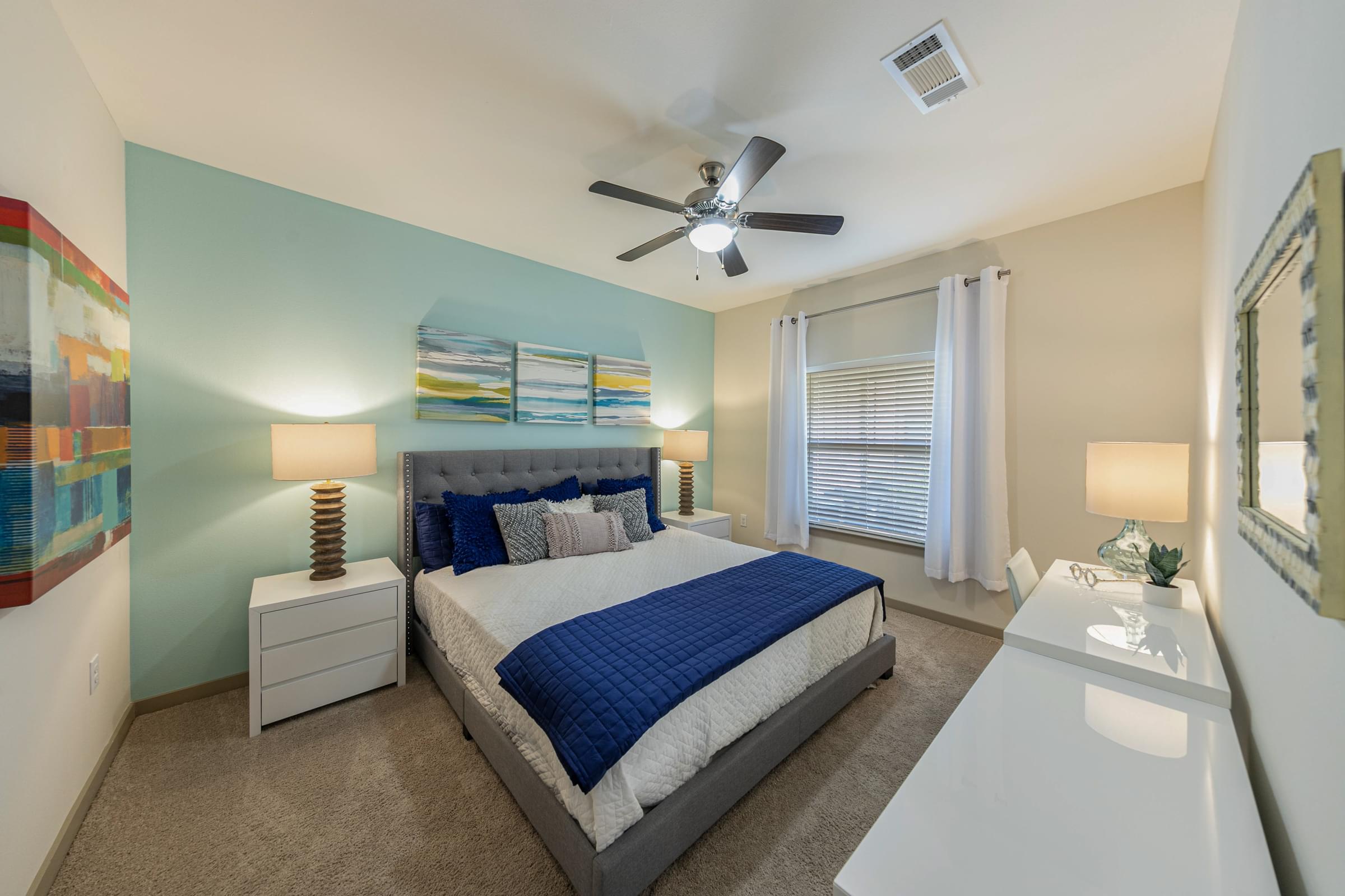 a bedroom with a bed and a ceiling fan