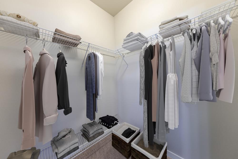 an image of a closet with clothes hanging on a rack
