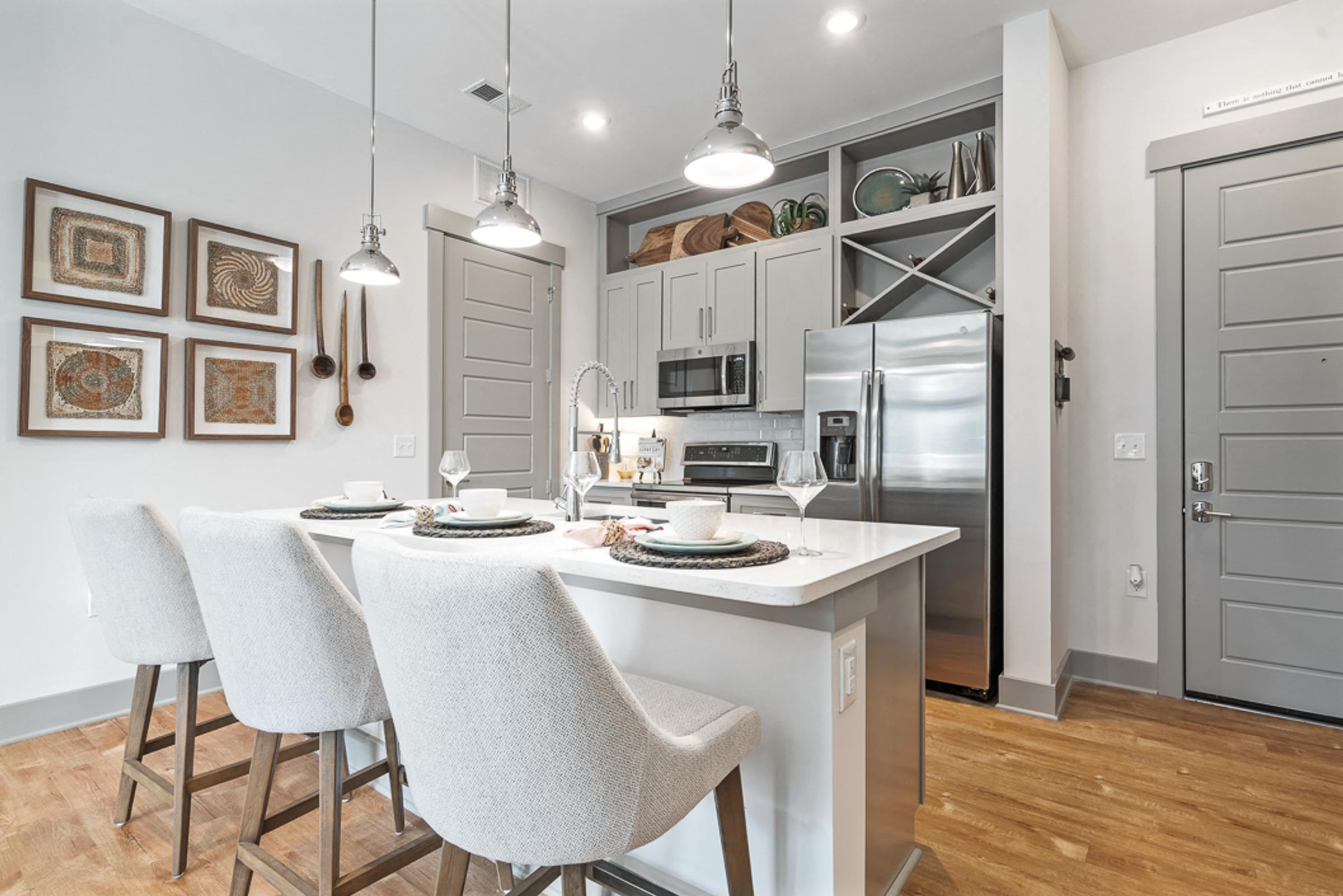 Well Appointed Kitchens with Double Stacked Cabinets and Large Under Mount Sinks