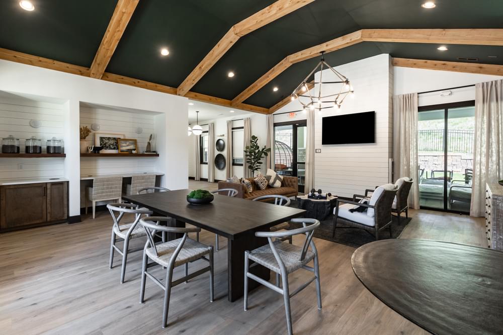 an open concept clubhouse and dining room with a dark wood dining table and chairs and a