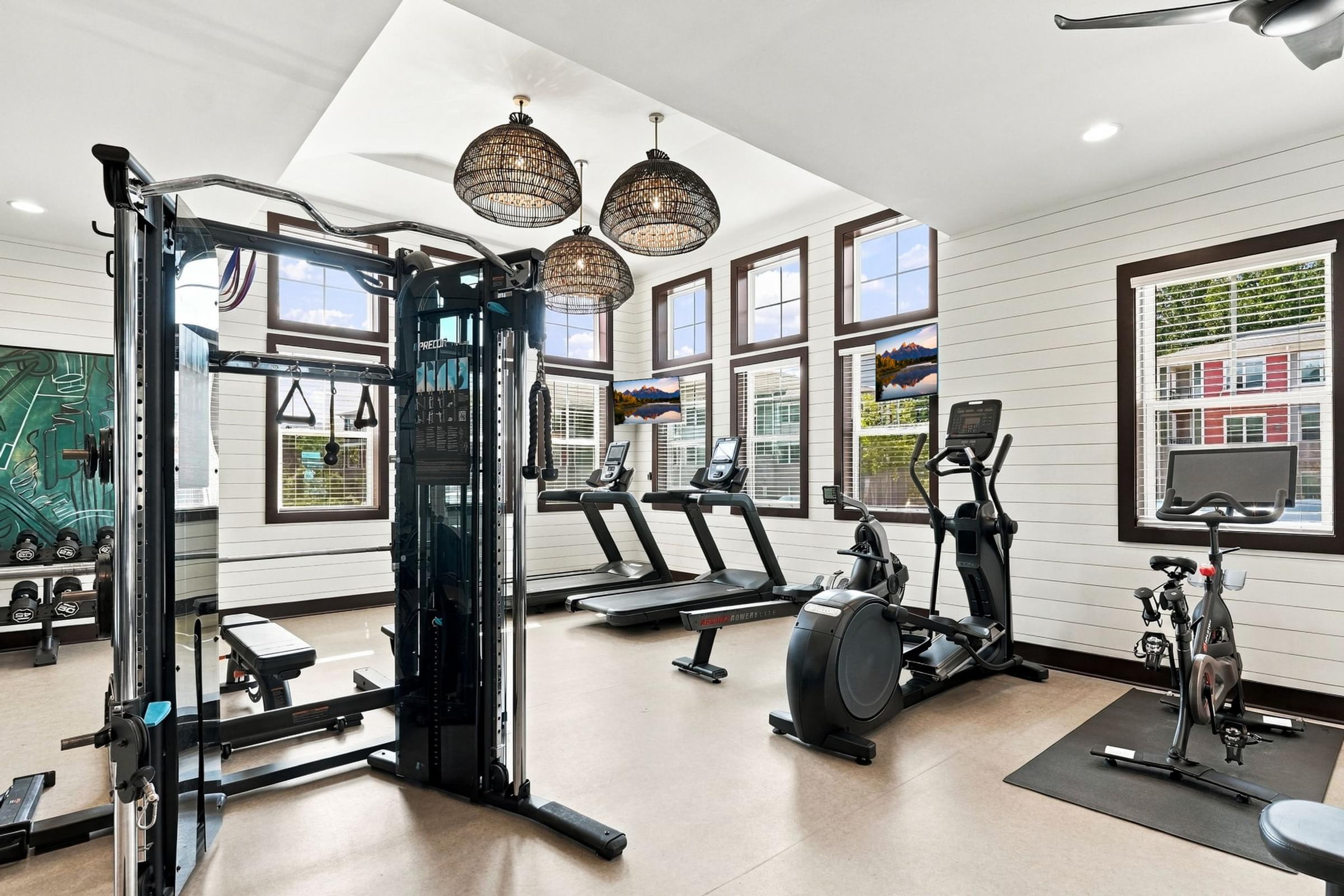A spacious home gym with a variety of exercise equipment.