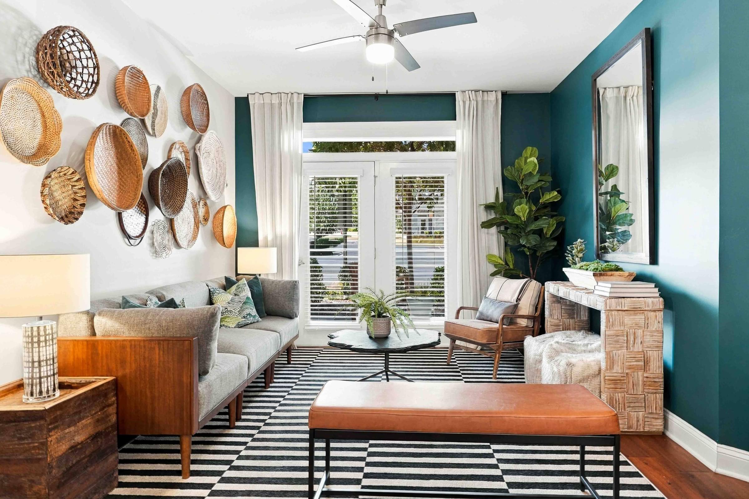 A living room with a fireplace and a ceiling fan.