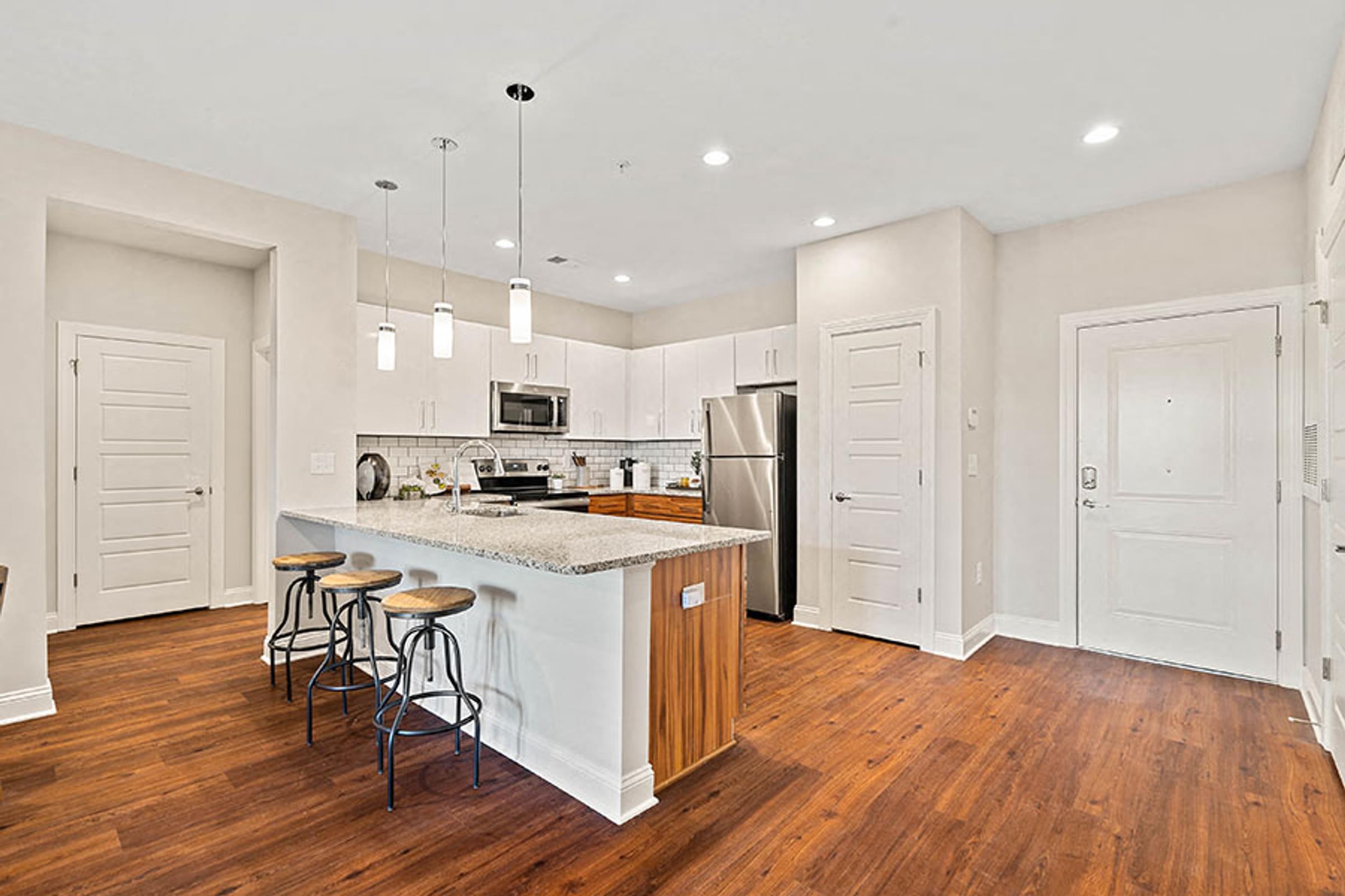 a kitchen with an island and stools