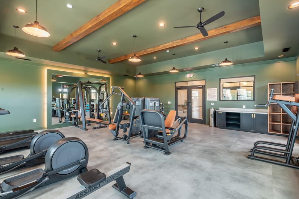 the gym in the clubhouse is equipped with weights and cardio equipment