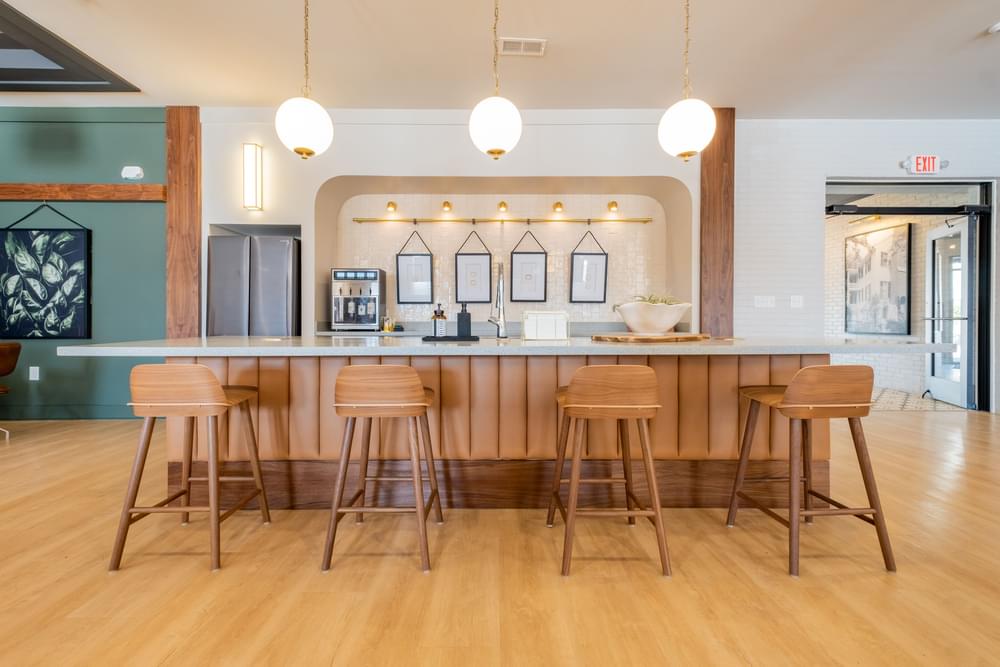 a kitchen with wooden bar stools and a counter top
