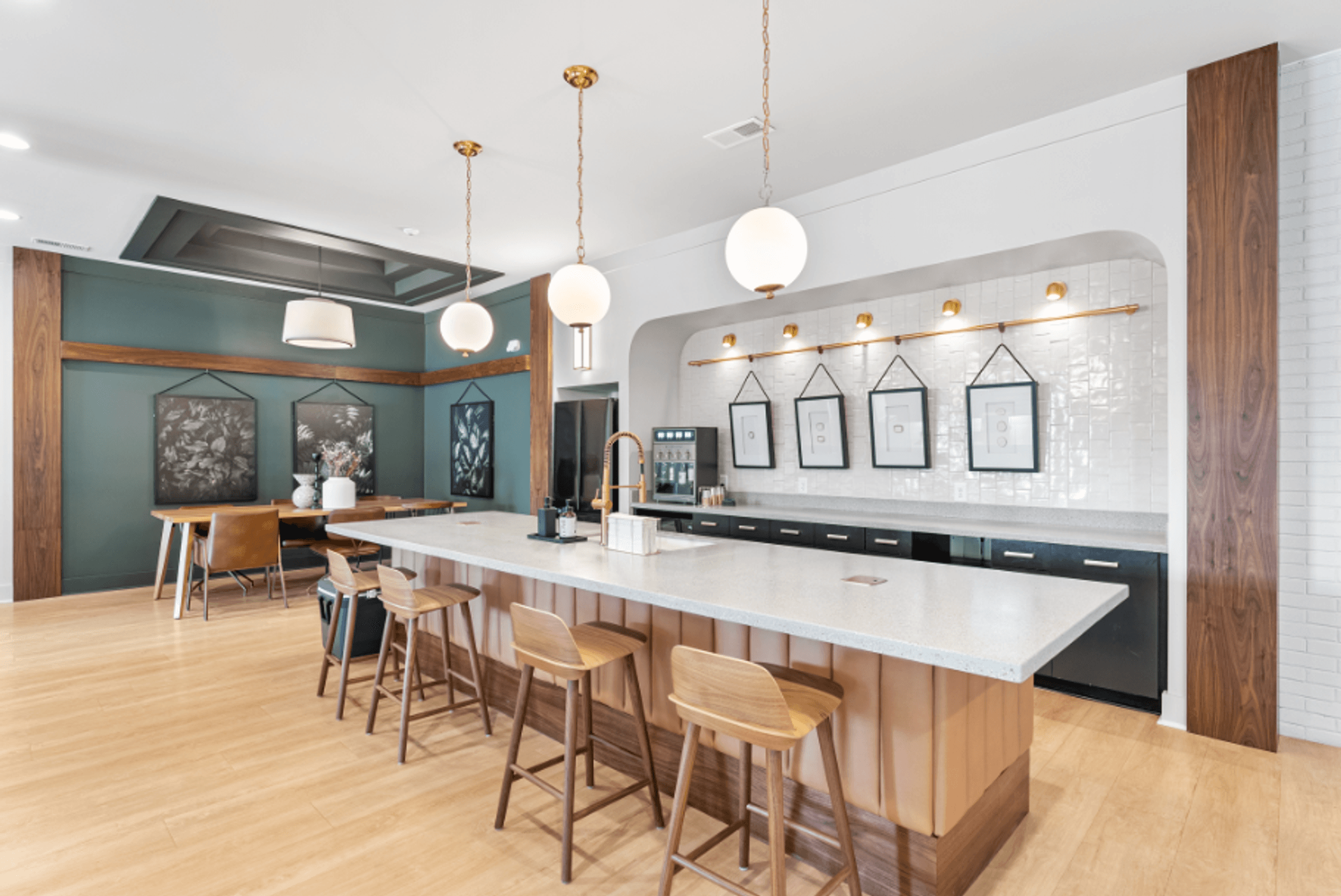 a large kitchen with a marble counter top and chairs