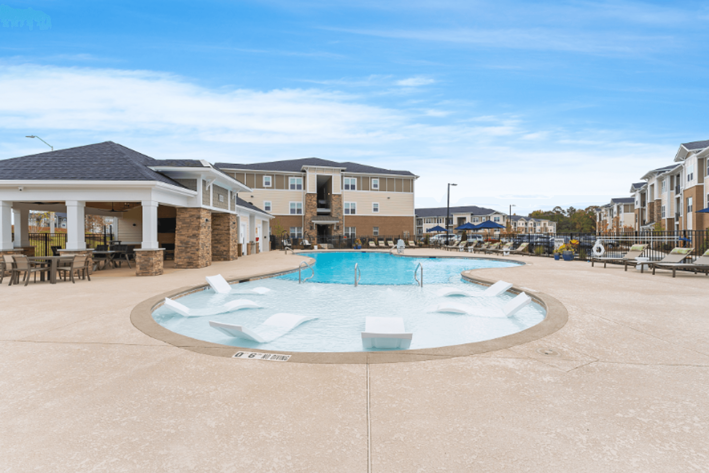 our apartments have a large pool with lounge chairs and tables