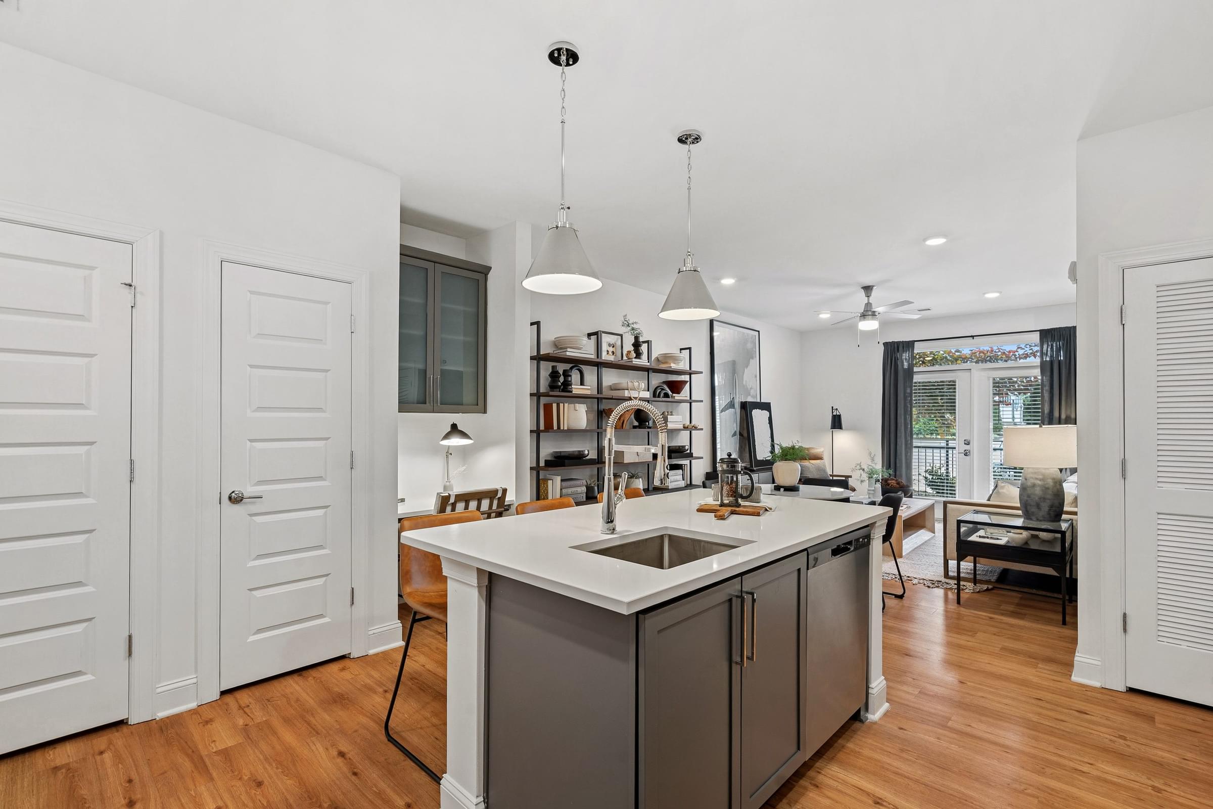 A kitchen with a white counter and a sink.