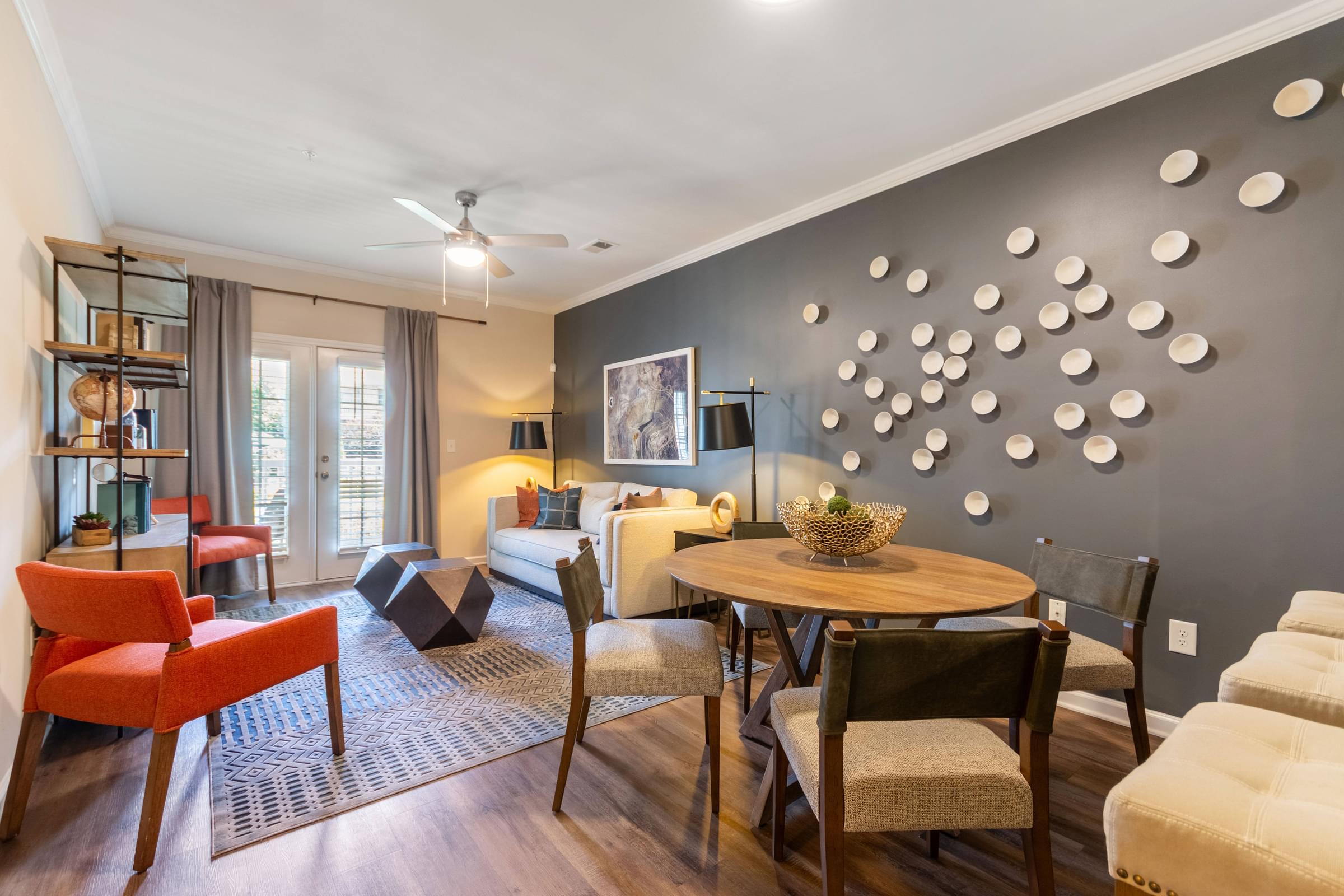A modern dining room with a round table and chairs.