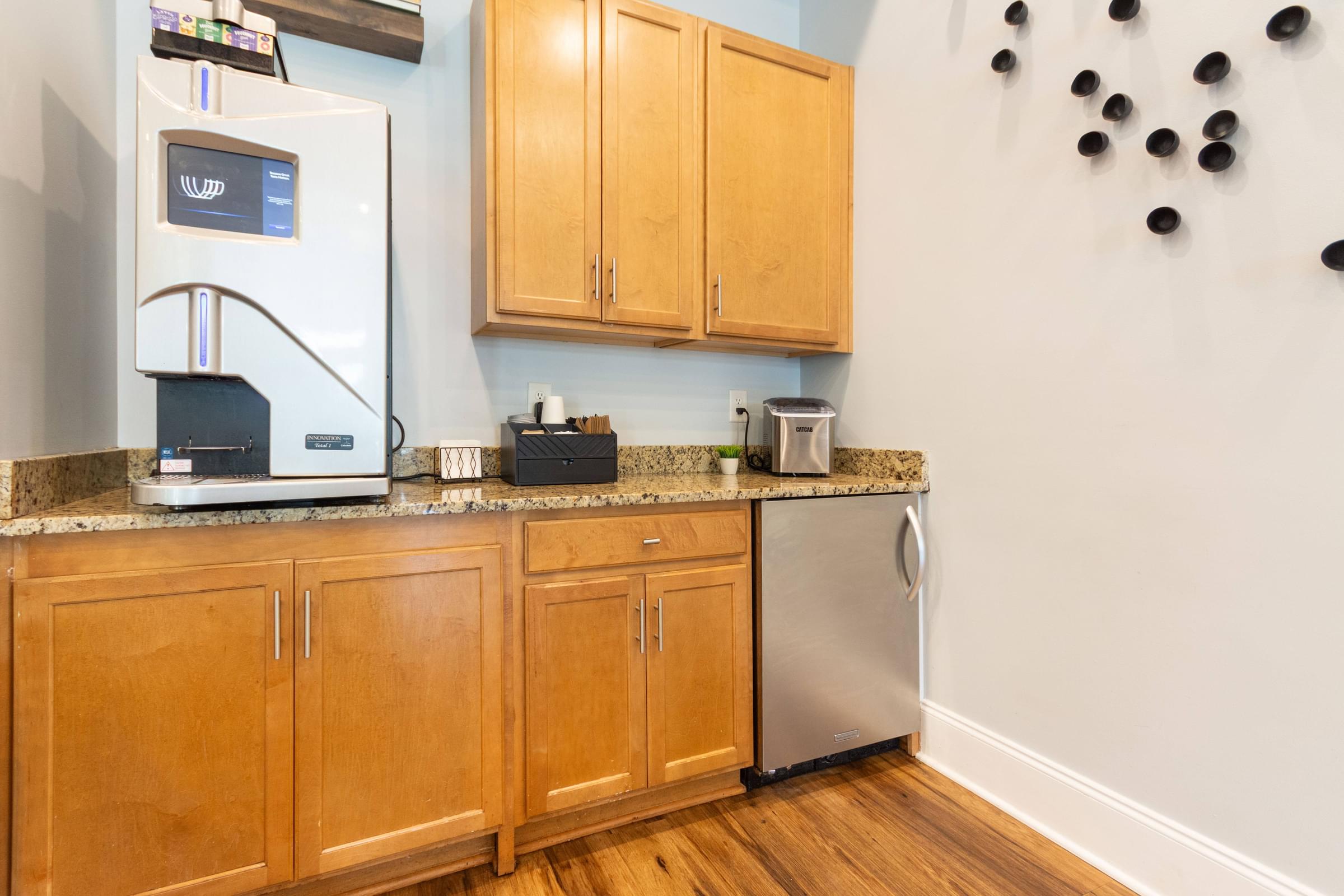 A kitchen with wooden cabinets and a stainless steel dishwasher.
