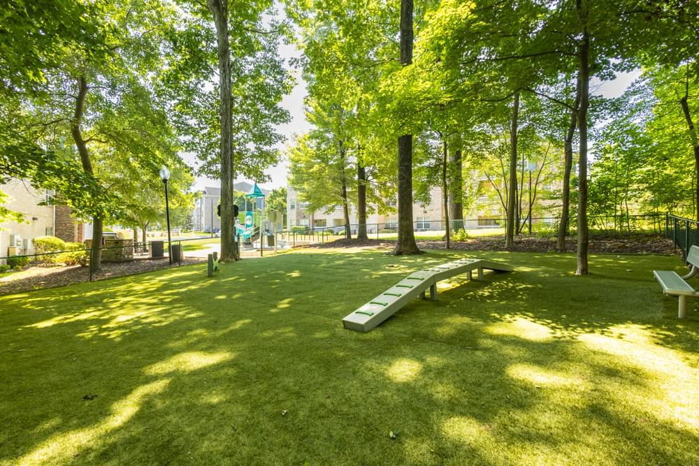 a park with trees and benches and a playground