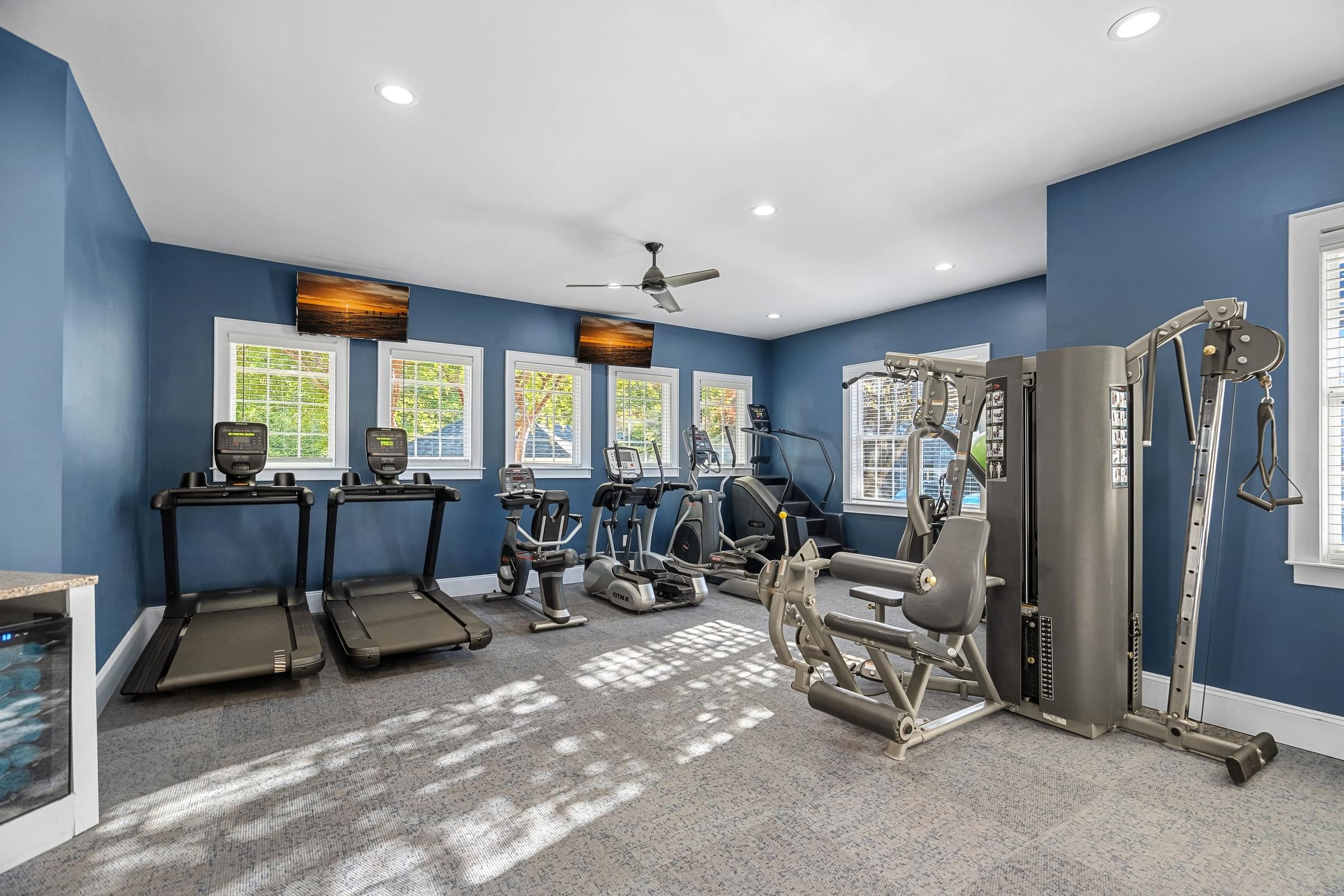 A spacious home gym with a variety of exercise equipment.