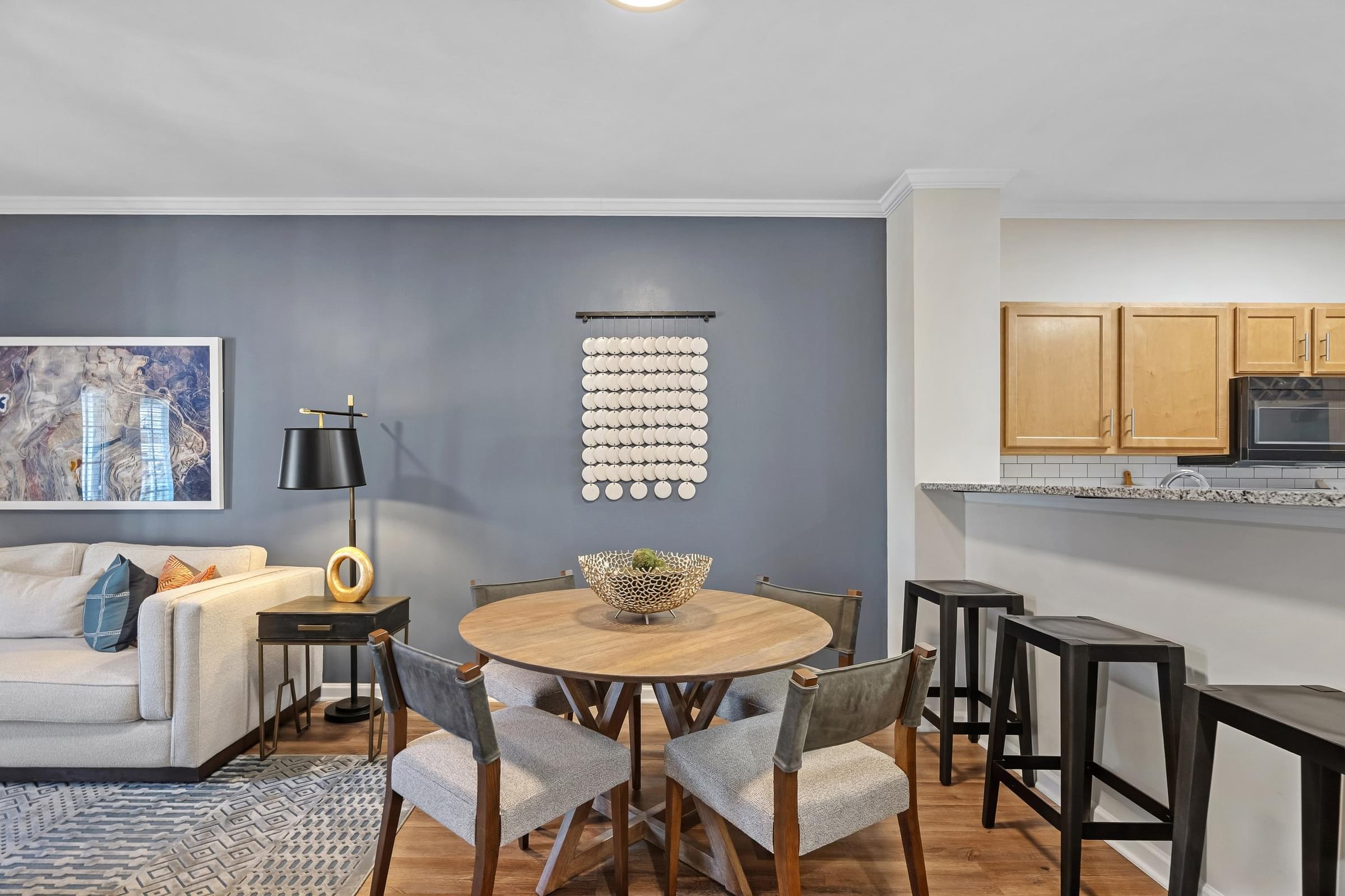 A dining room with a round table and chairs.