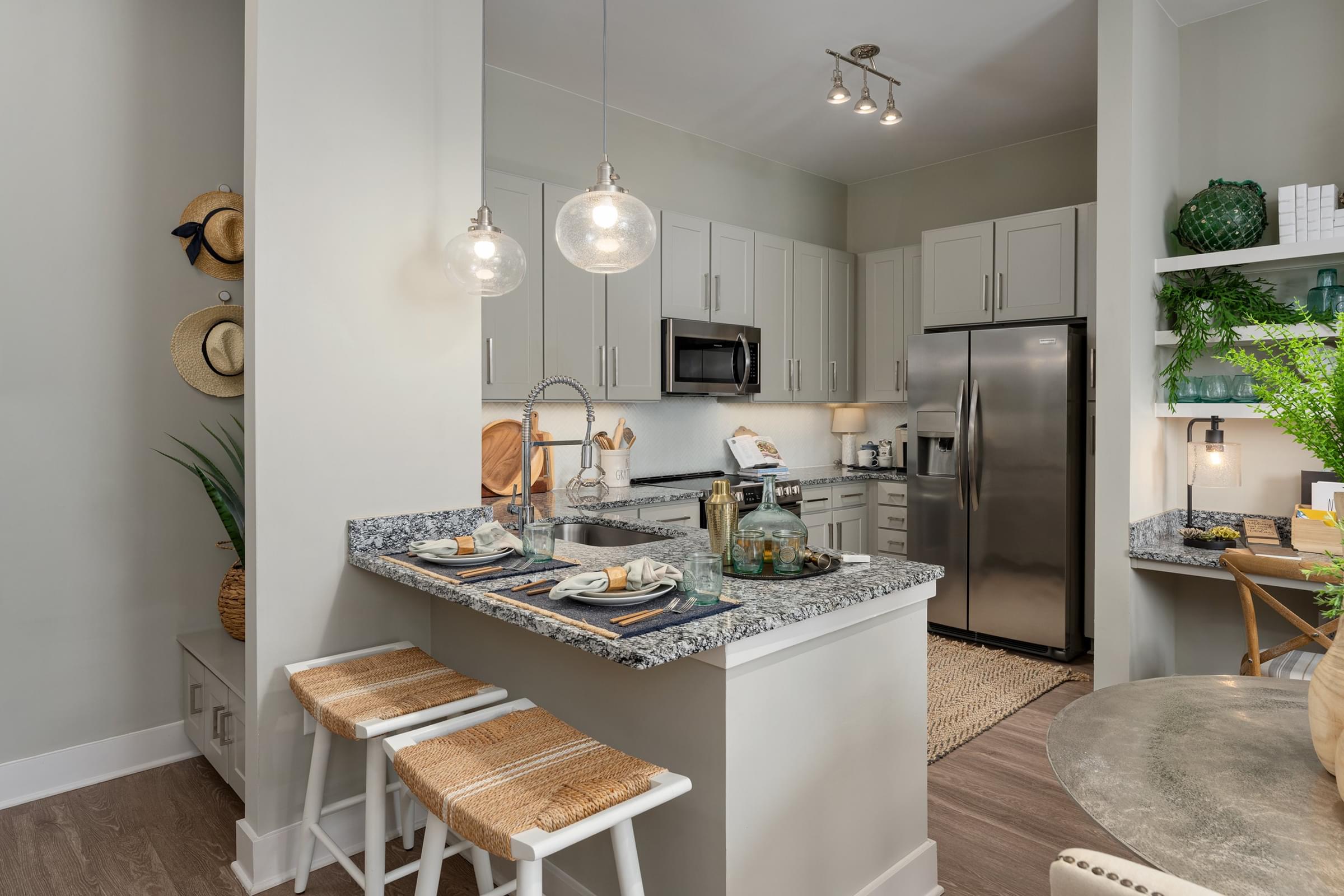 Designer Kitchen Featuring Granite Countertops and Modern Stainless Steel Appliances