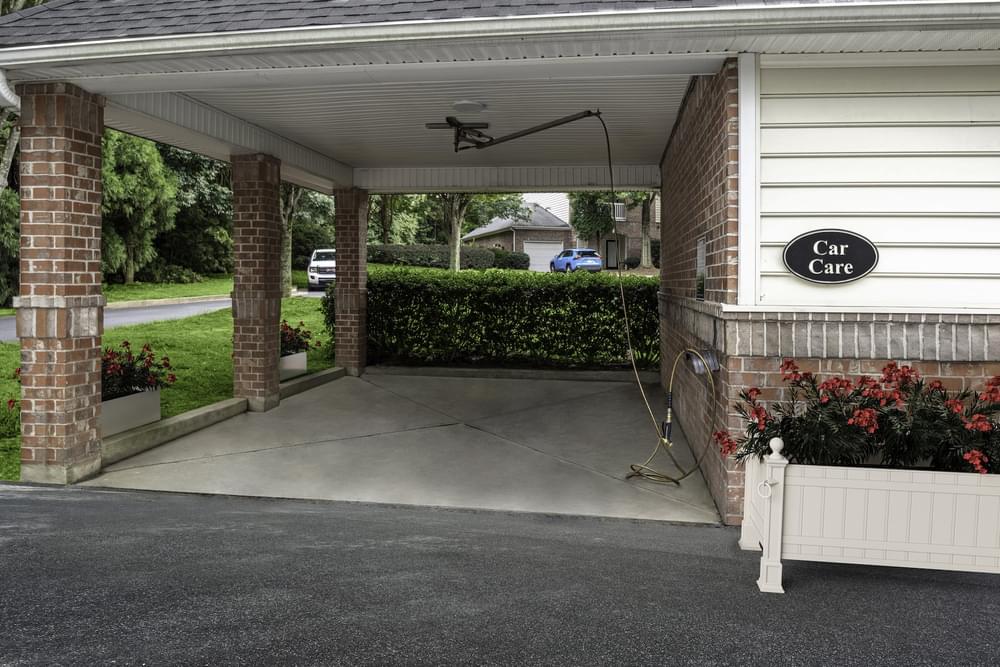 the front porch of a car dealership with a concrete driveway
