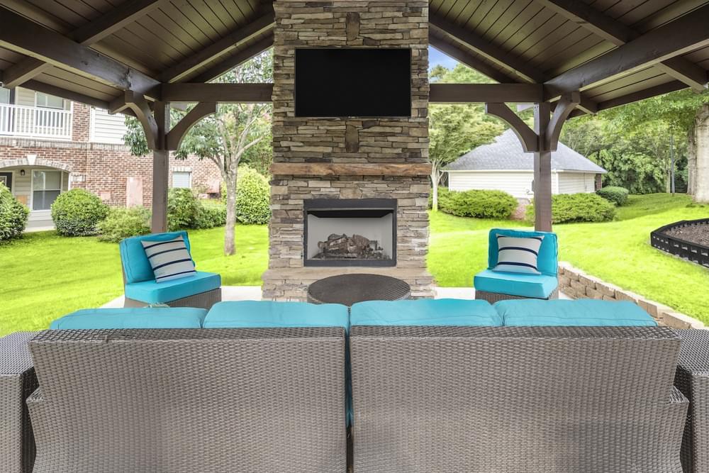 a backyard patio with a fireplace and a table and chairs