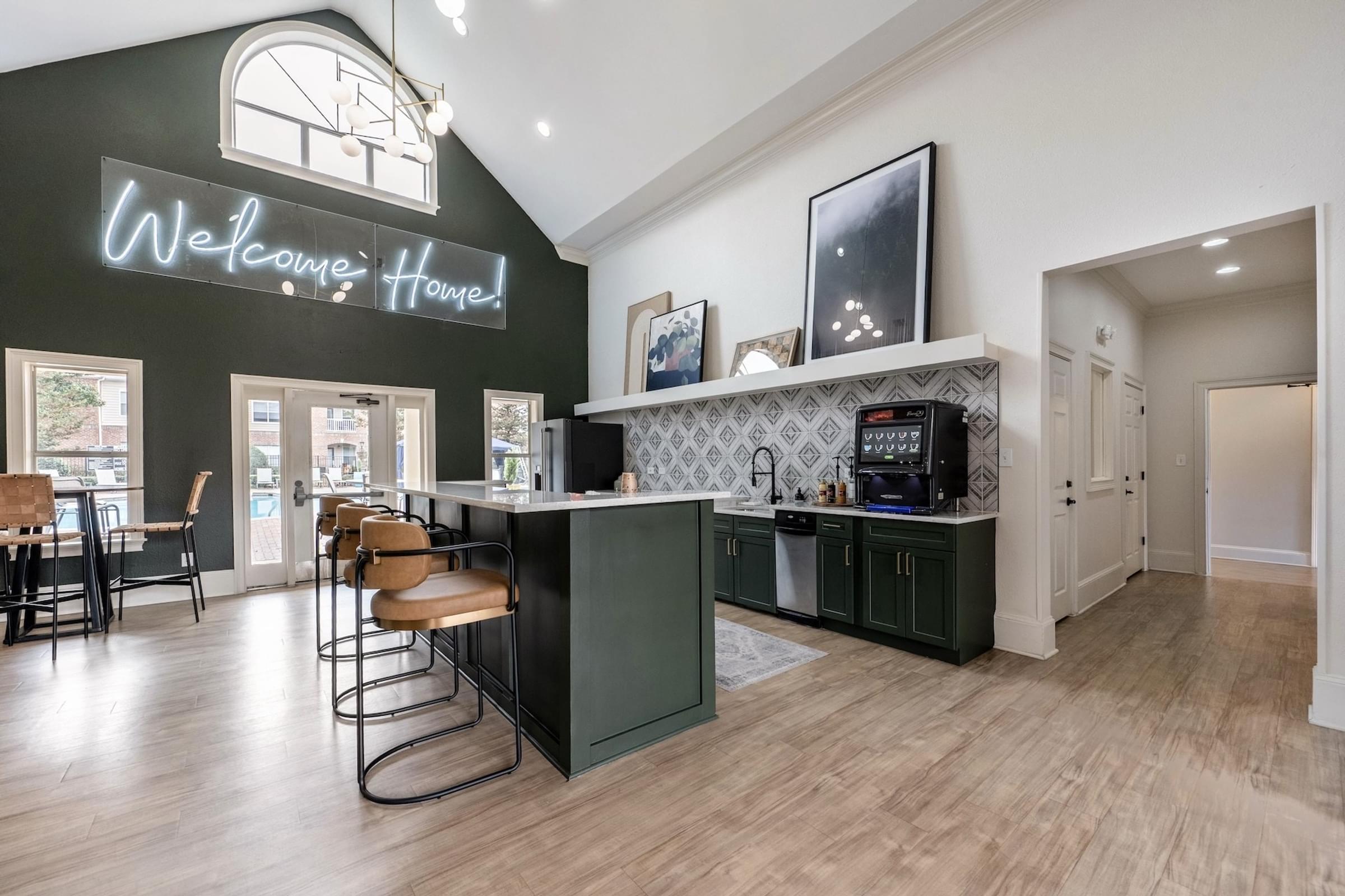 A modern kitchen with a bar area and a neon sign that says