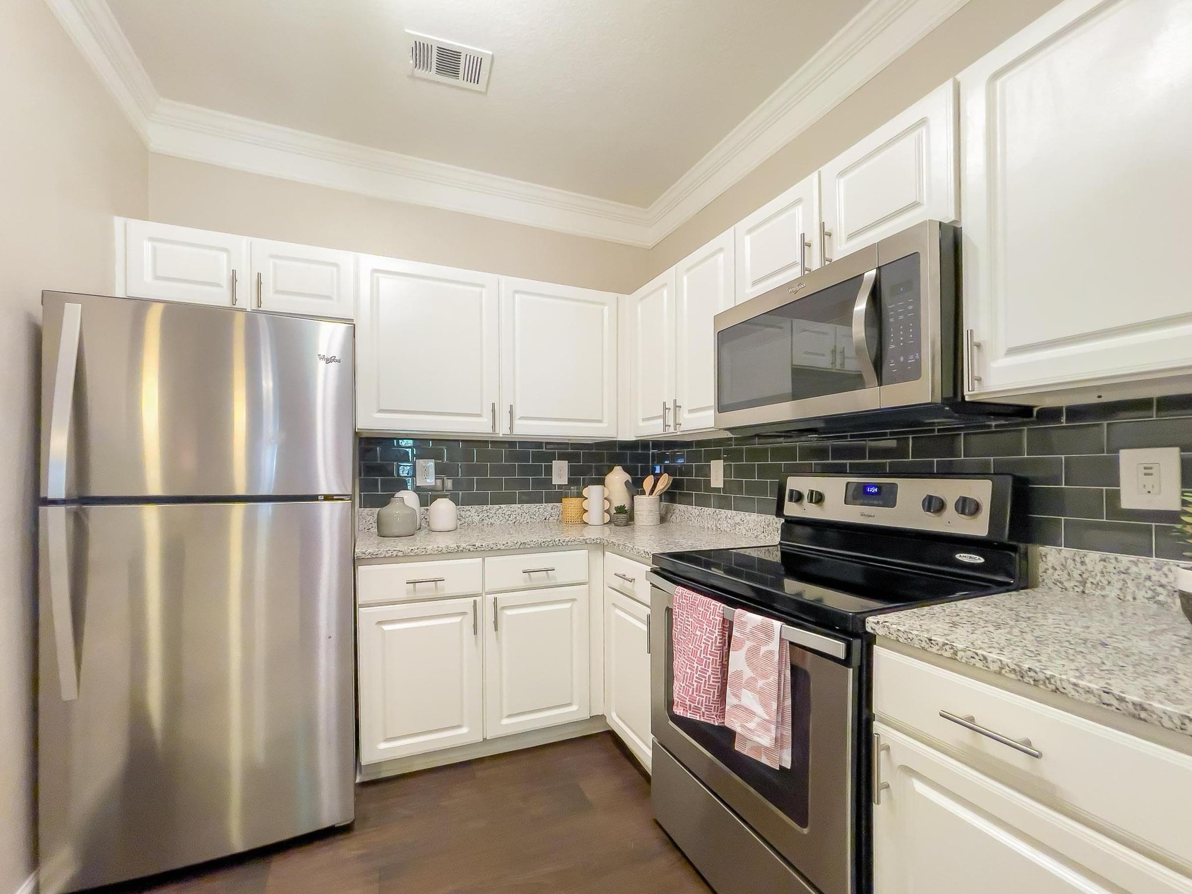 Upgraded Kitchen Featuring Subway Tile Backsplash and Breakfast Bar