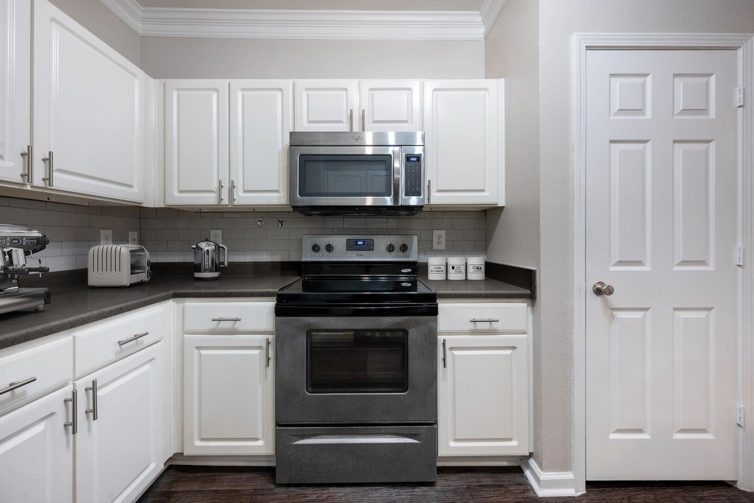 Upgraded Kitchen Featuring Subway Tile Backsplash and Breakfast Bar