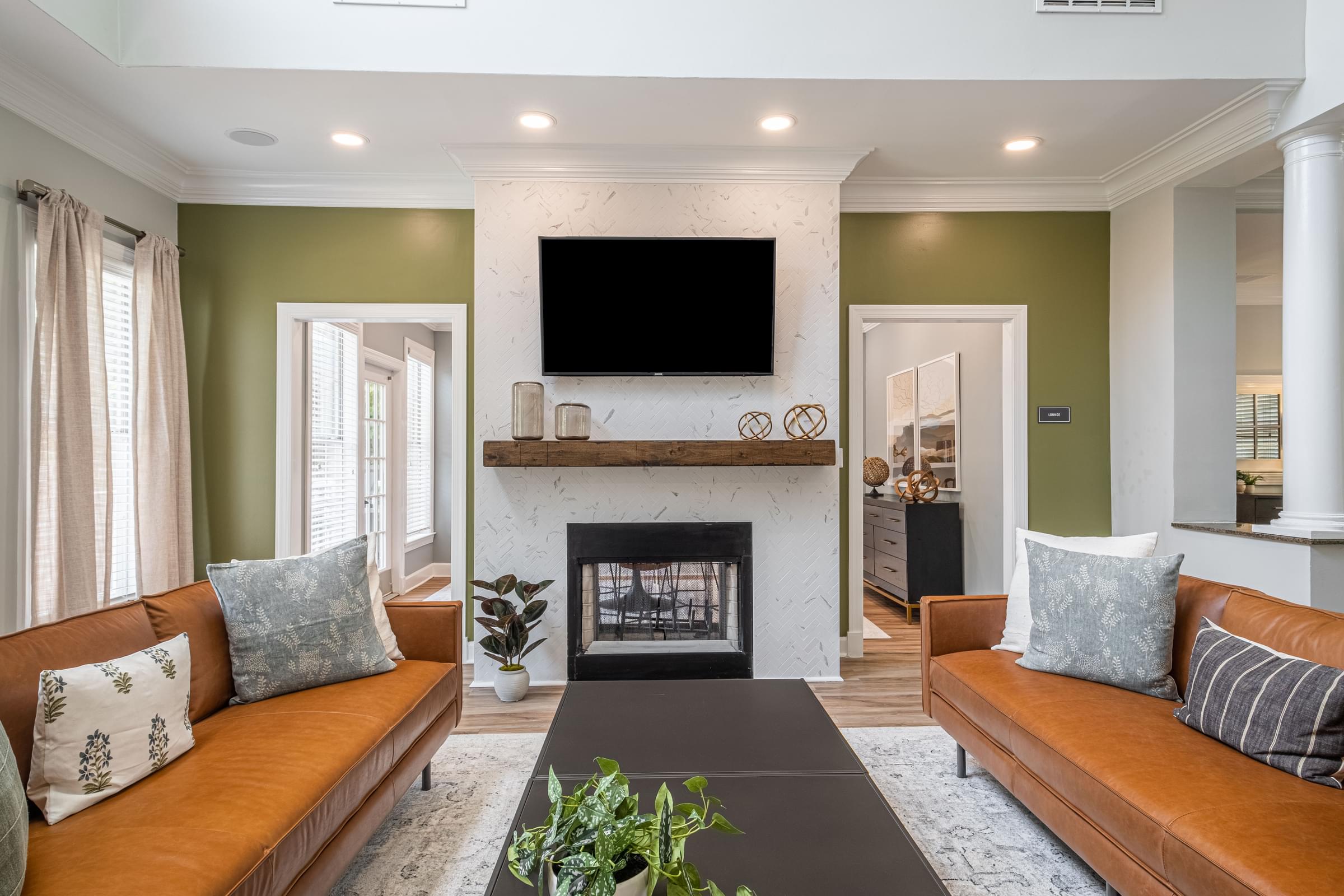 a living room with a fireplace and couches