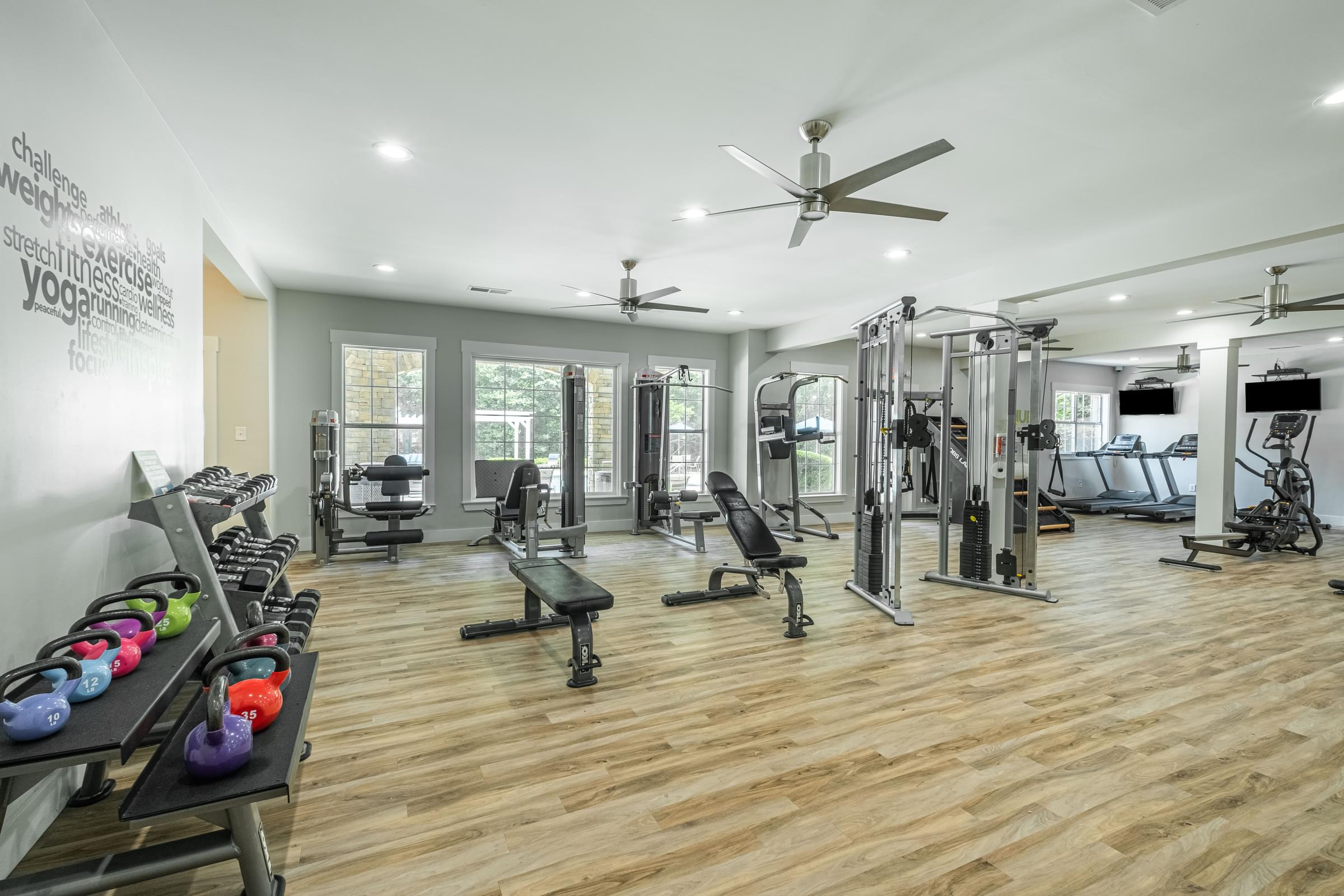 a spacious gym with weights and cardio machines