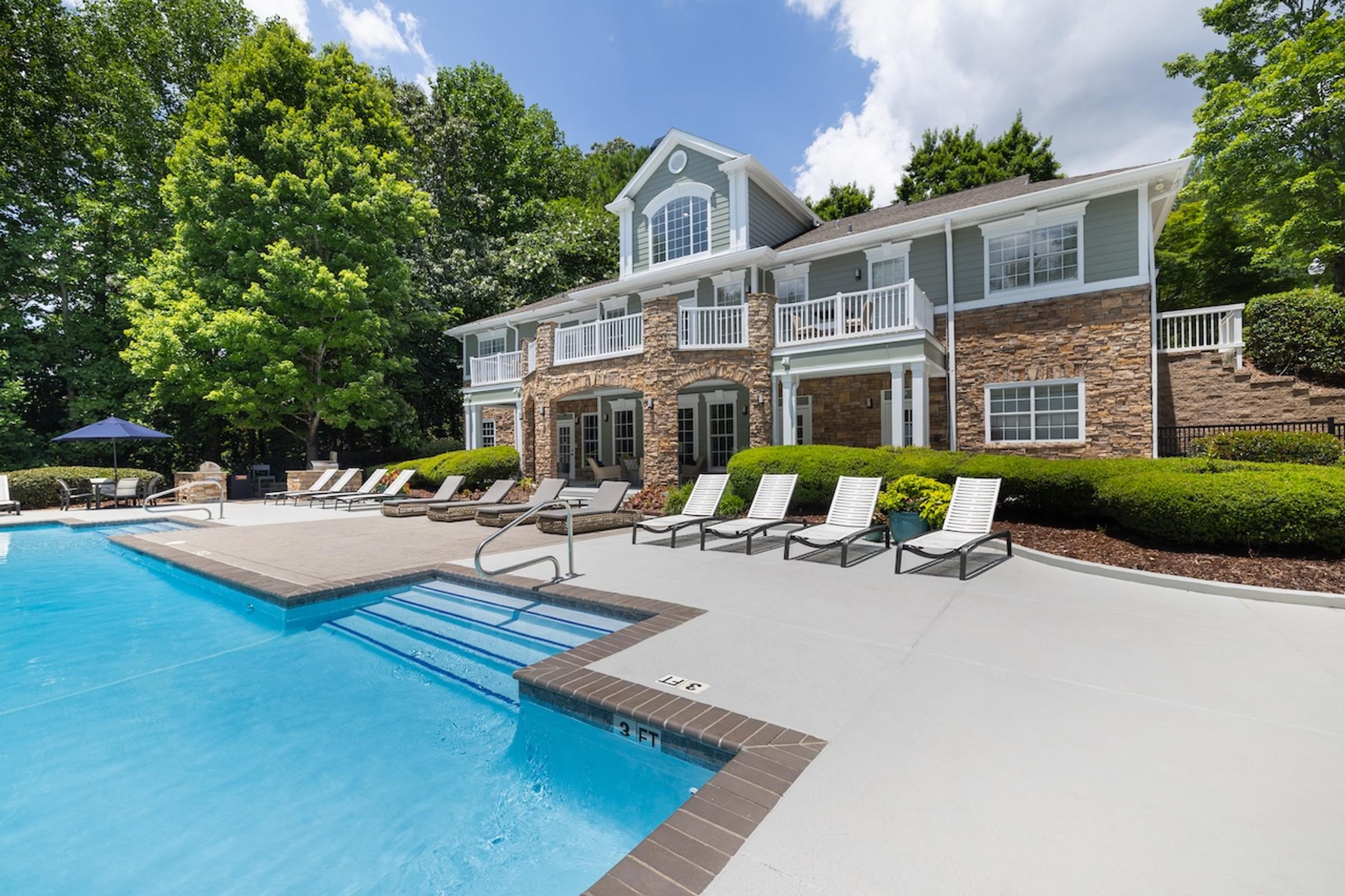 a large swimming pool in front of a house