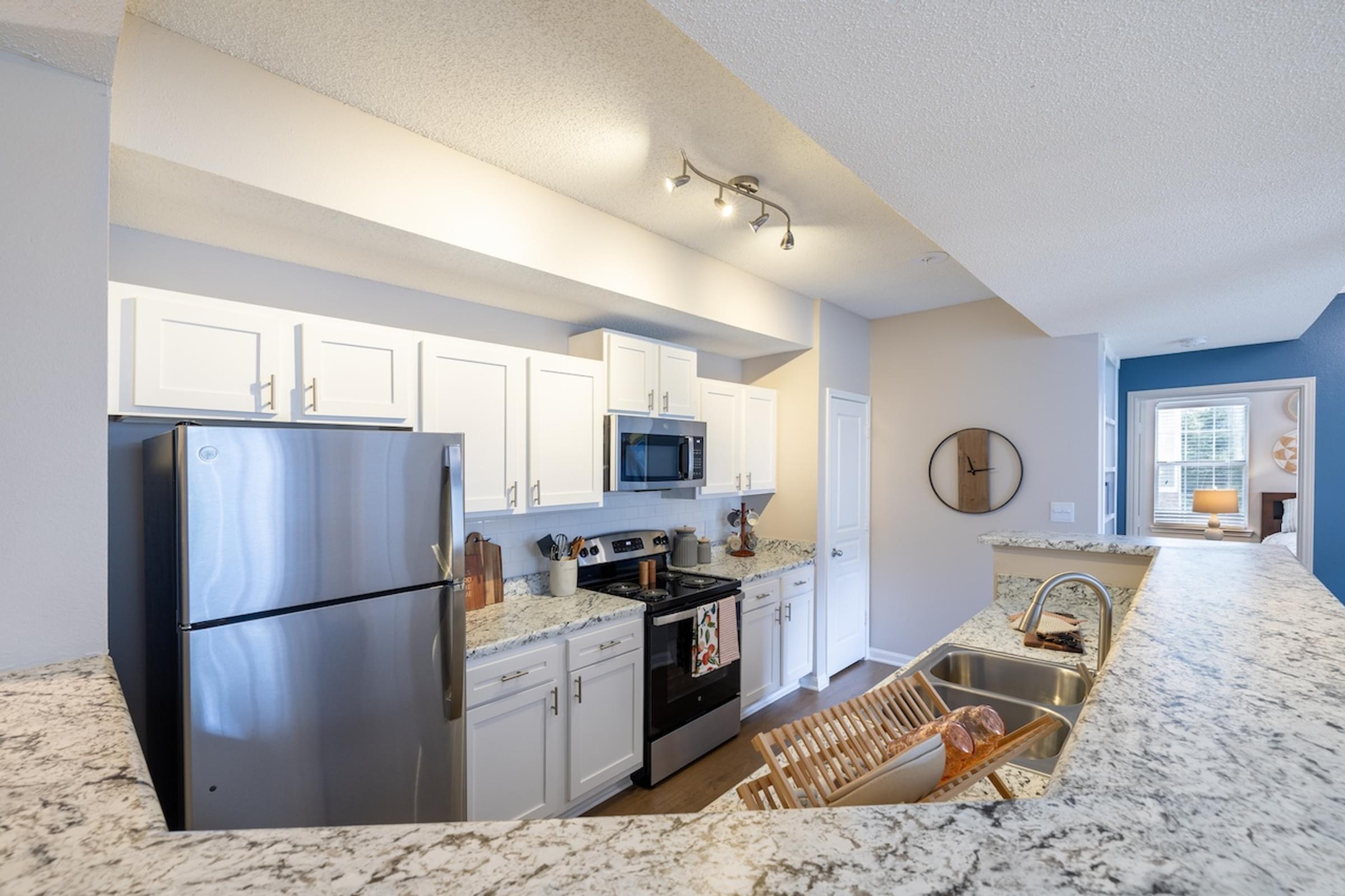 Open Kitchen with Stainless Steel Appliances and Granite Countertops
