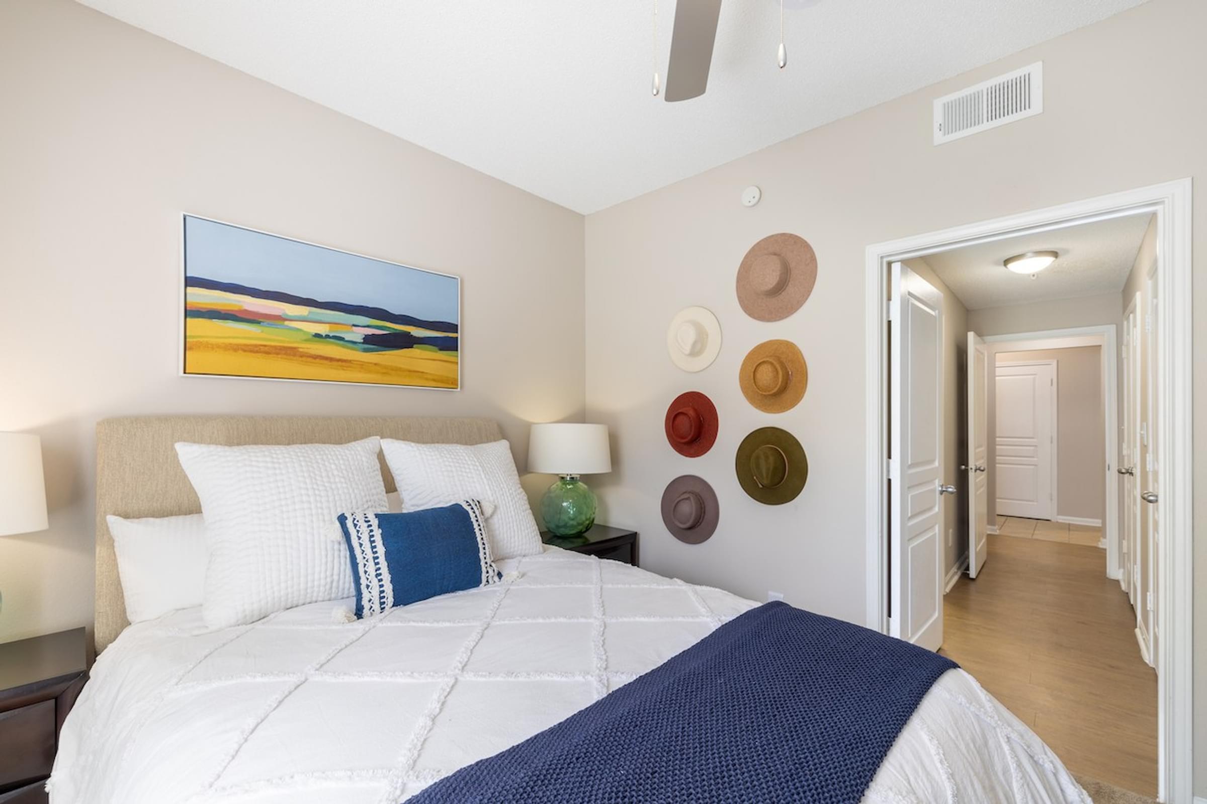 a bedroom with a white bed and pillows