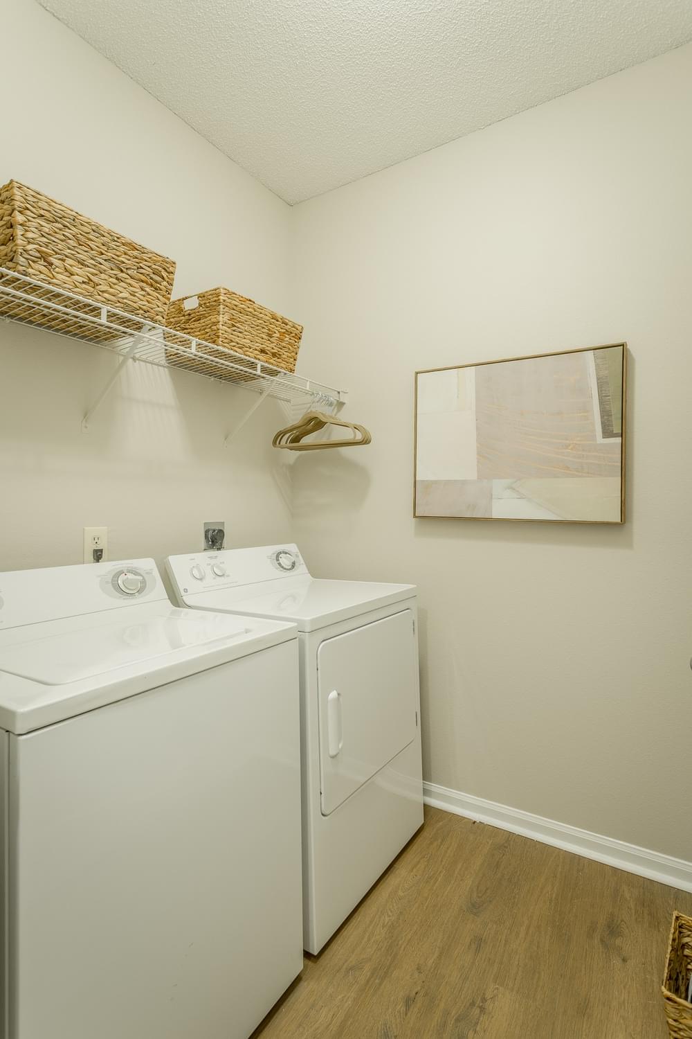 a washer and dryer in a room with a window and a white wall