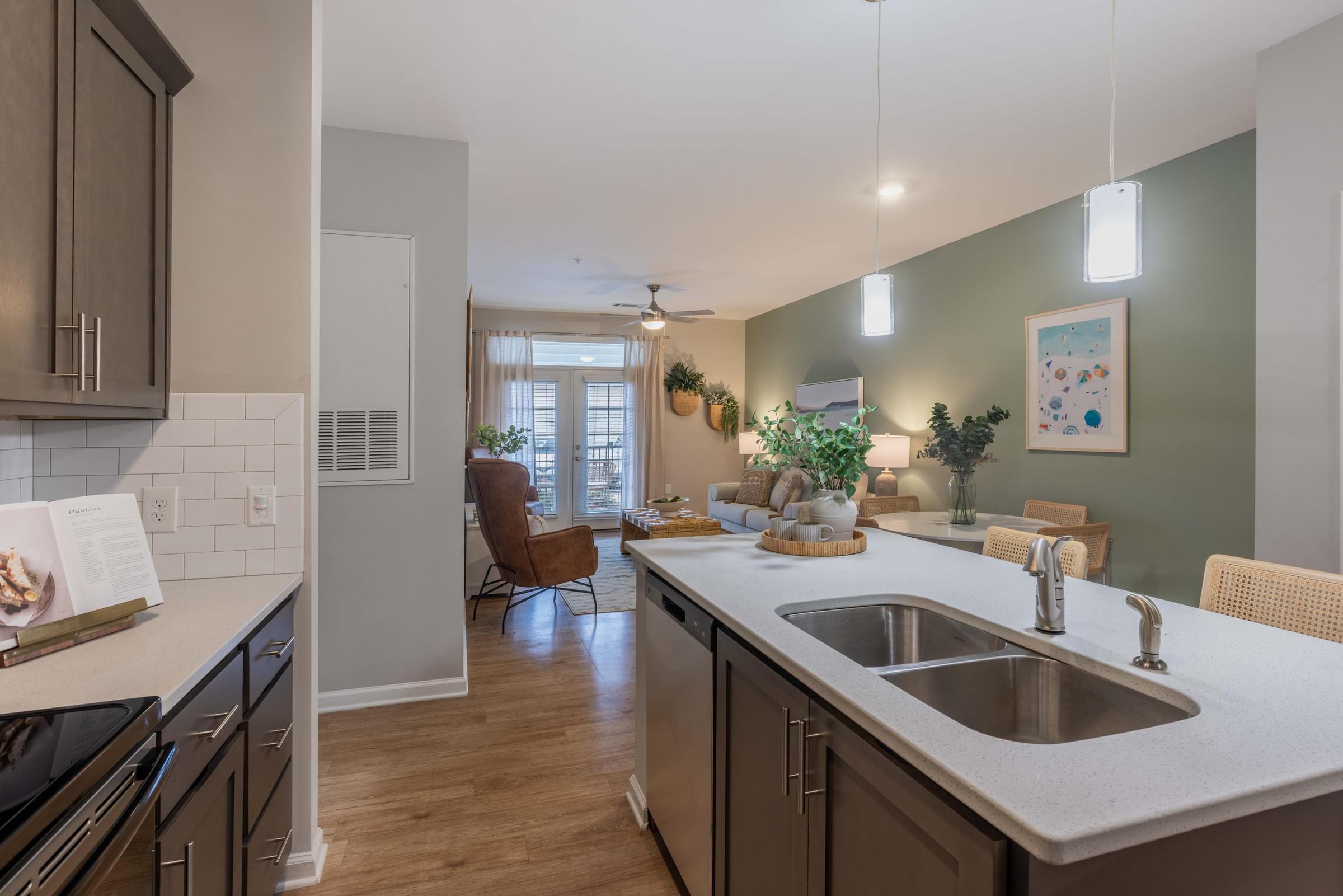 an open kitchen and living room with a sink and a window