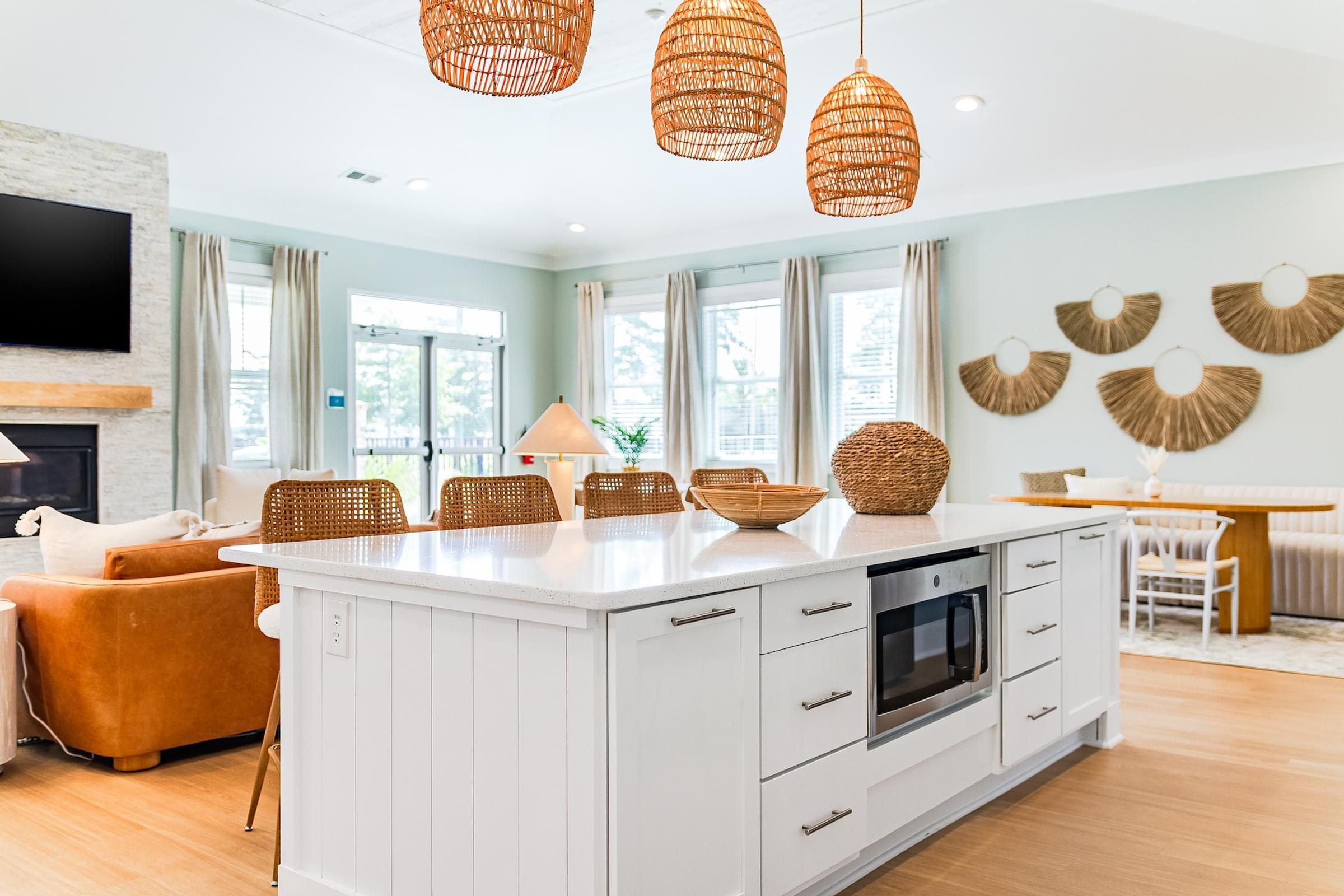 a kitchen with a large island and a living room with a fireplace