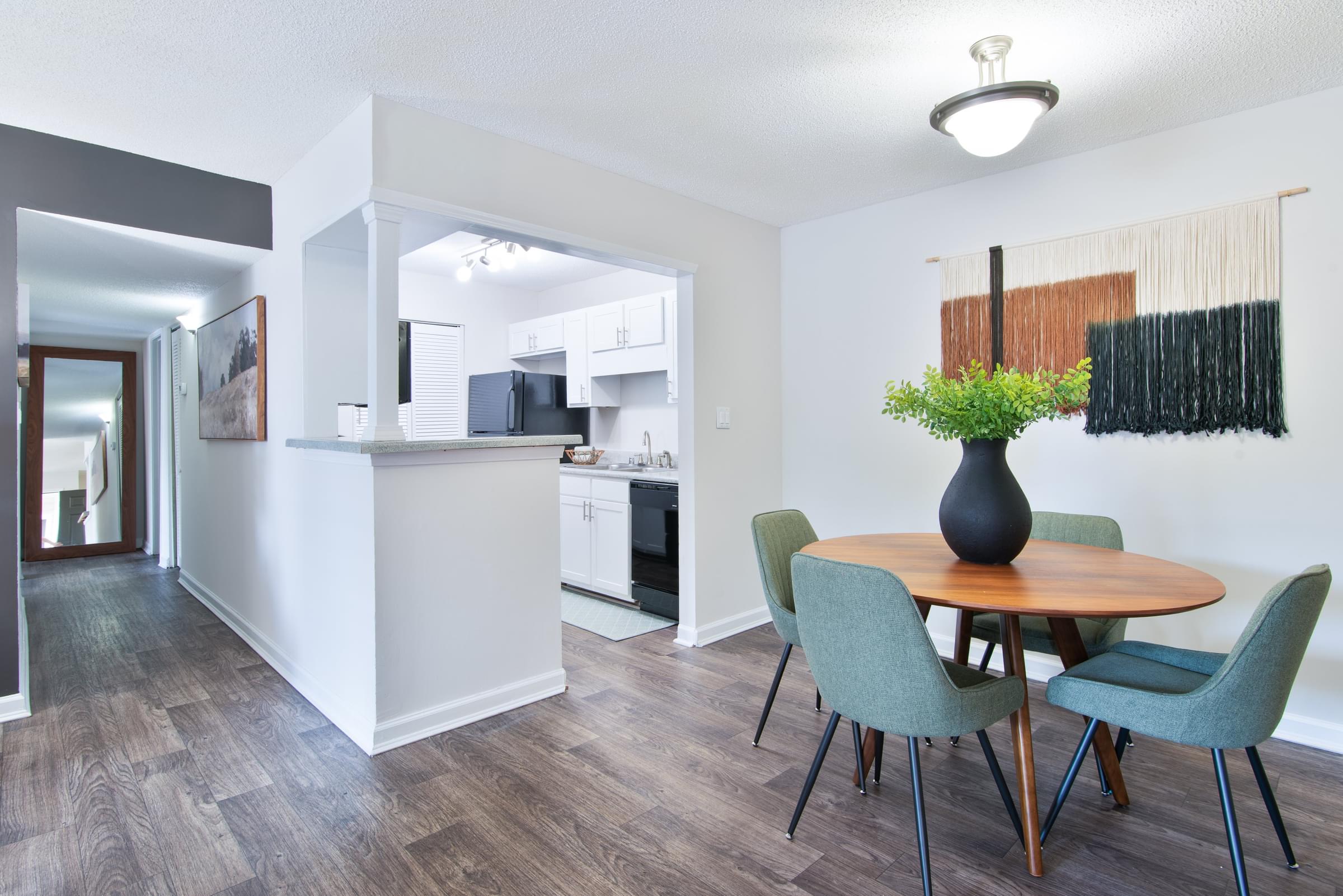 A dining room with a table and chairs.