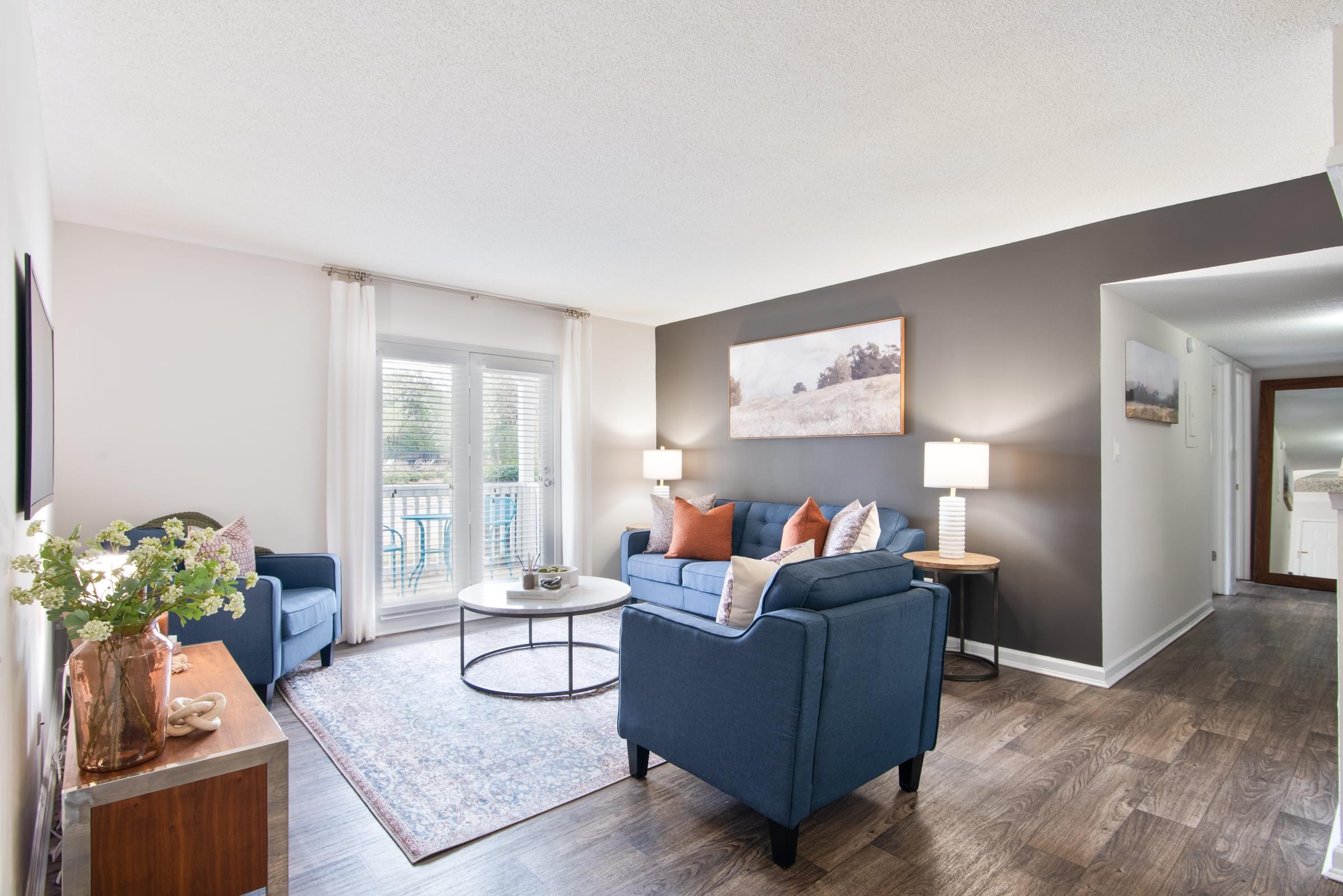 A living room with a blue couch and a coffee table.
