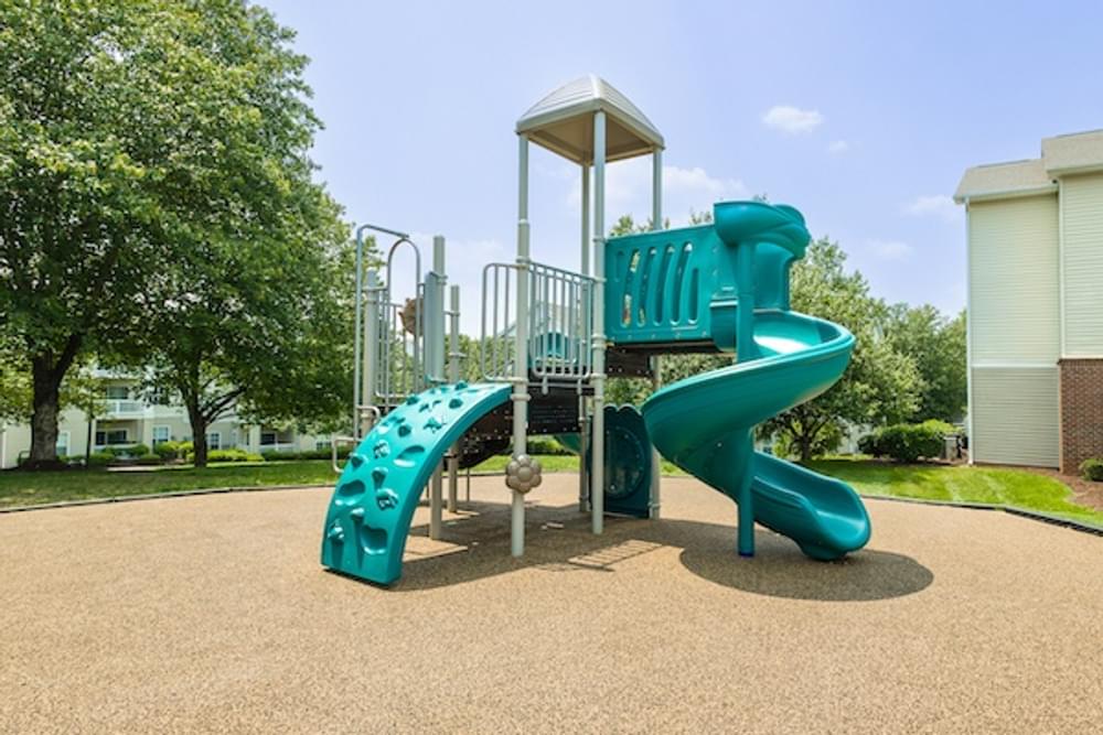a playground with a slide in a park