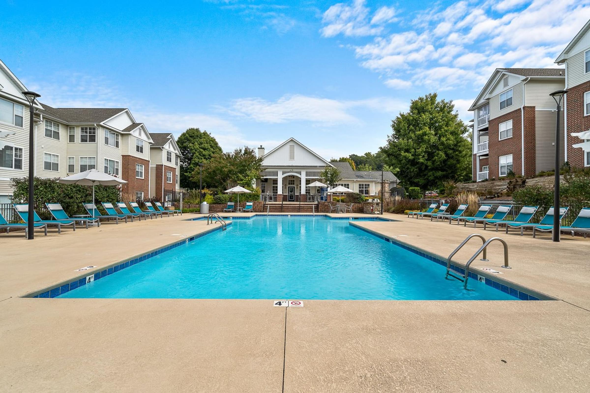 Large Swimming Pool with Lounge Chairs and Umbrellas