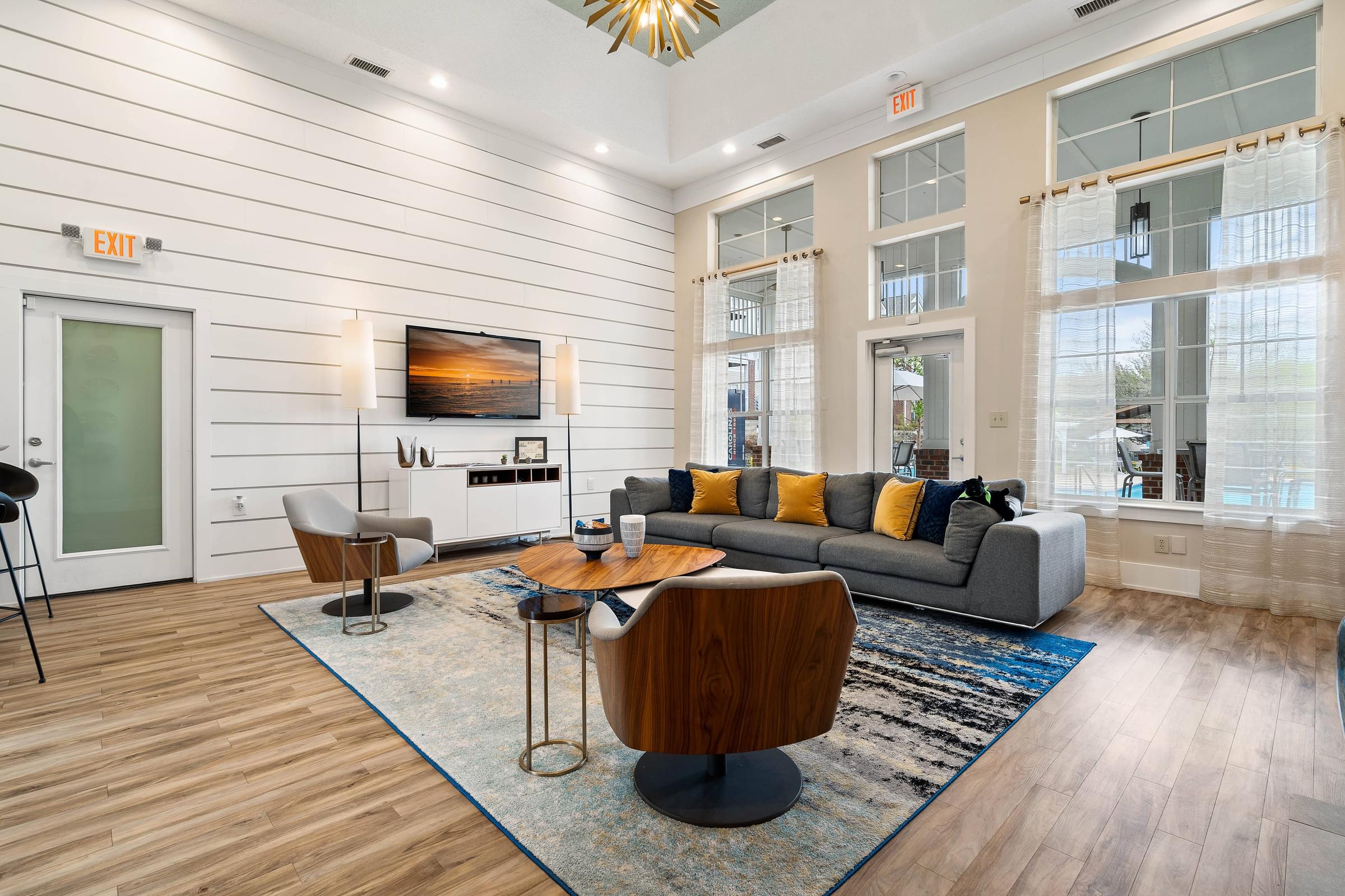 A living room with a grey couch and a wooden coffee table.