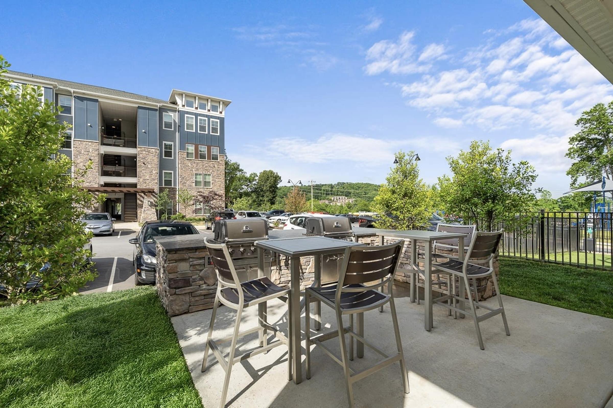 A patio with a table and chairs is in front of a building.